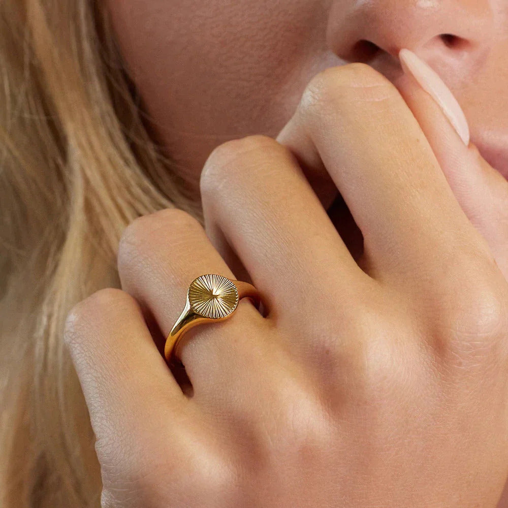 Model wearing gold signet ring