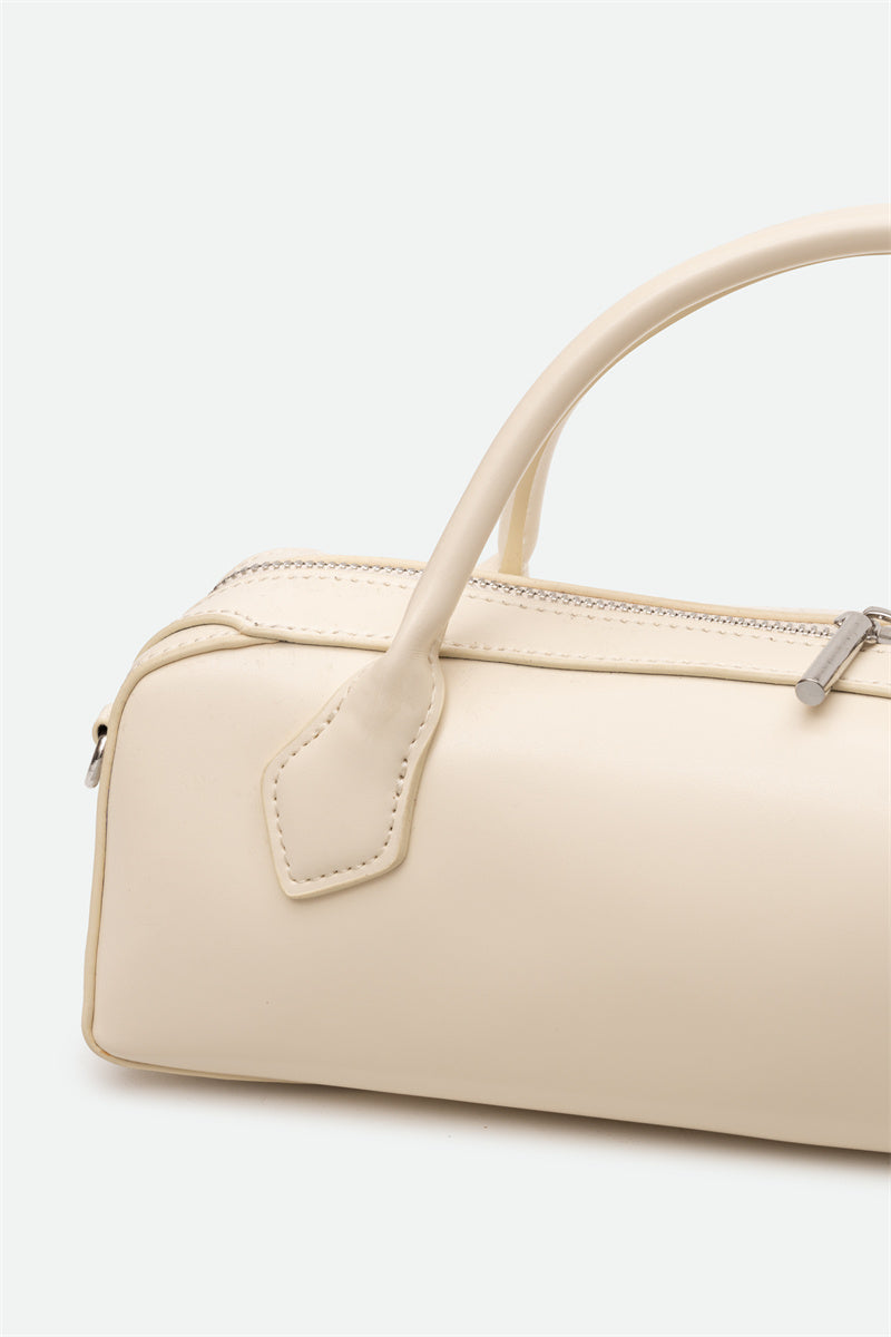 Beige handbag with a handle on a light gray background