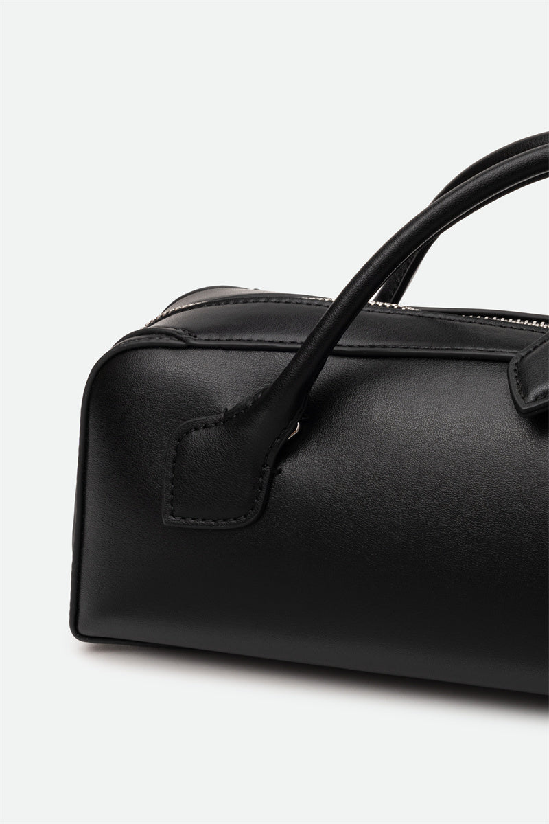 Black leather handbag with handle on a white background