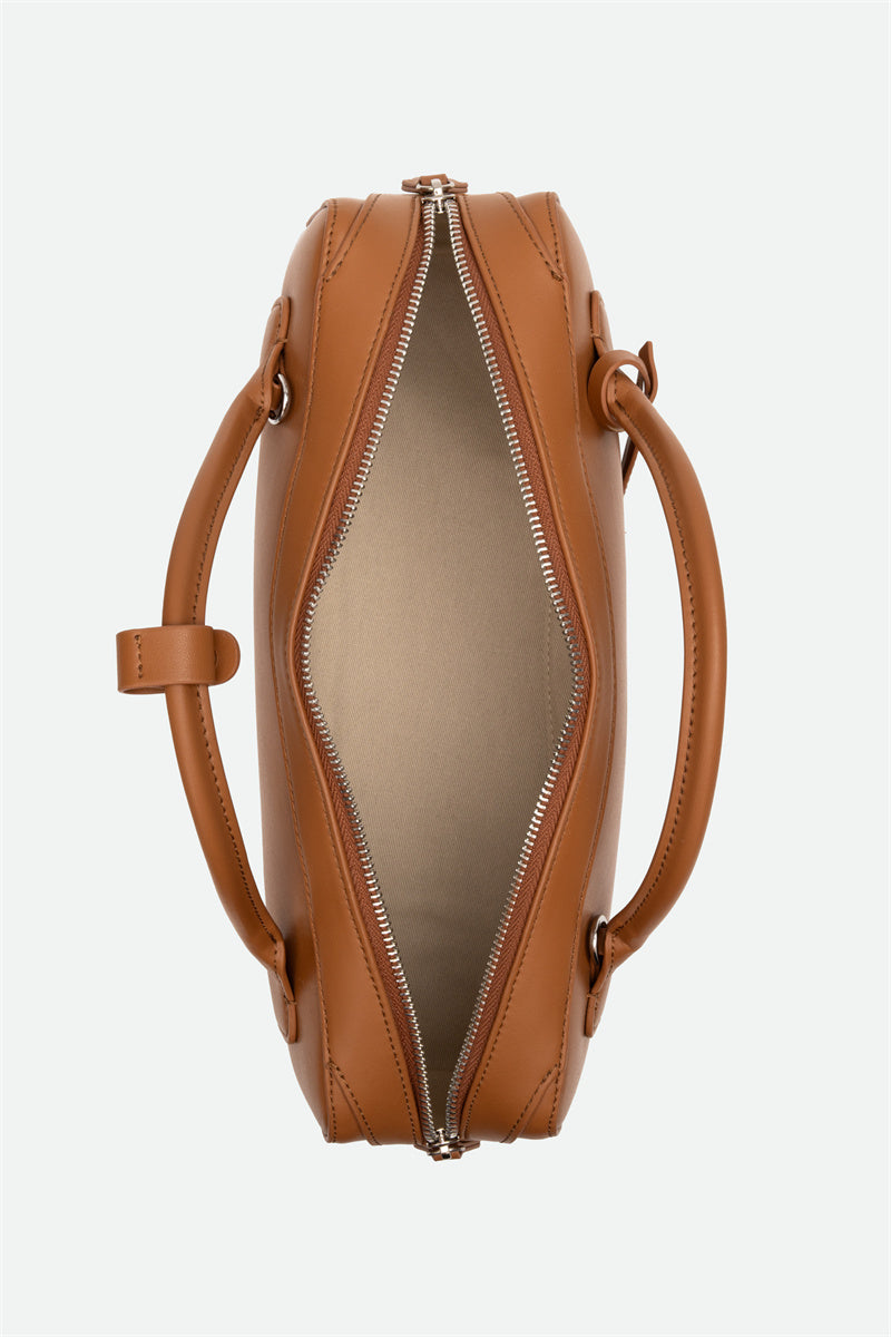 Brown leather handbag with a zipper on a white background