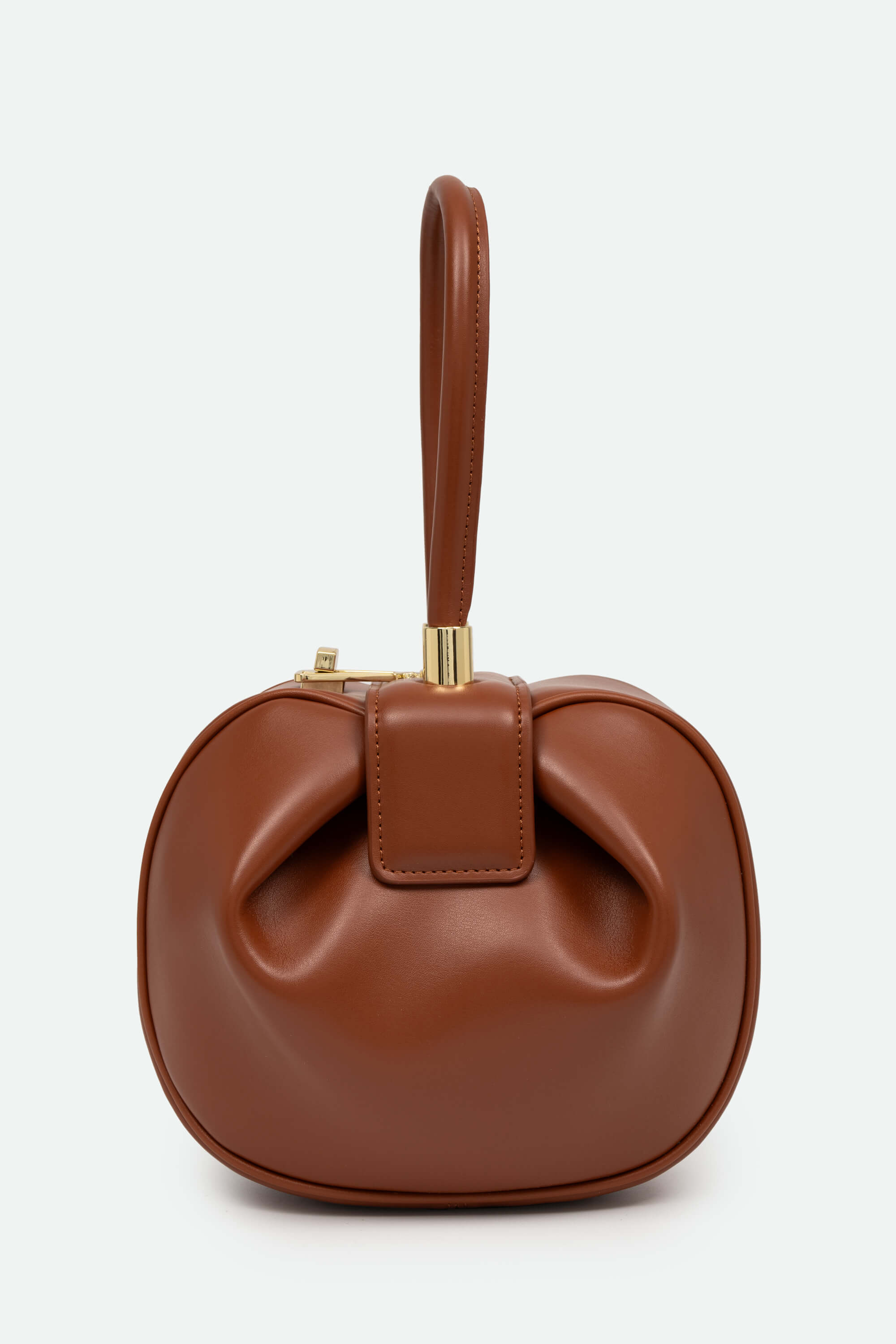 Brown leather handbag with a bow detail on a white background