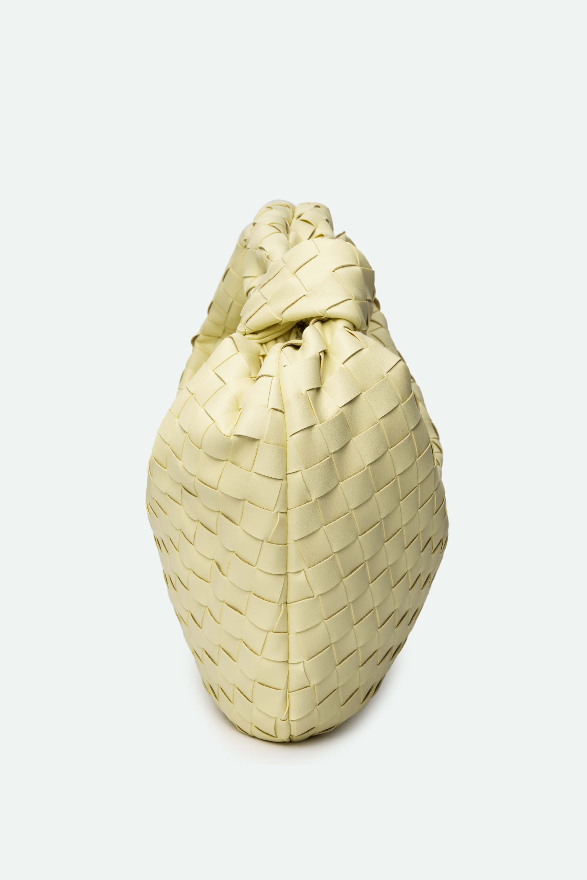 Cream-colored woven bag on a white background