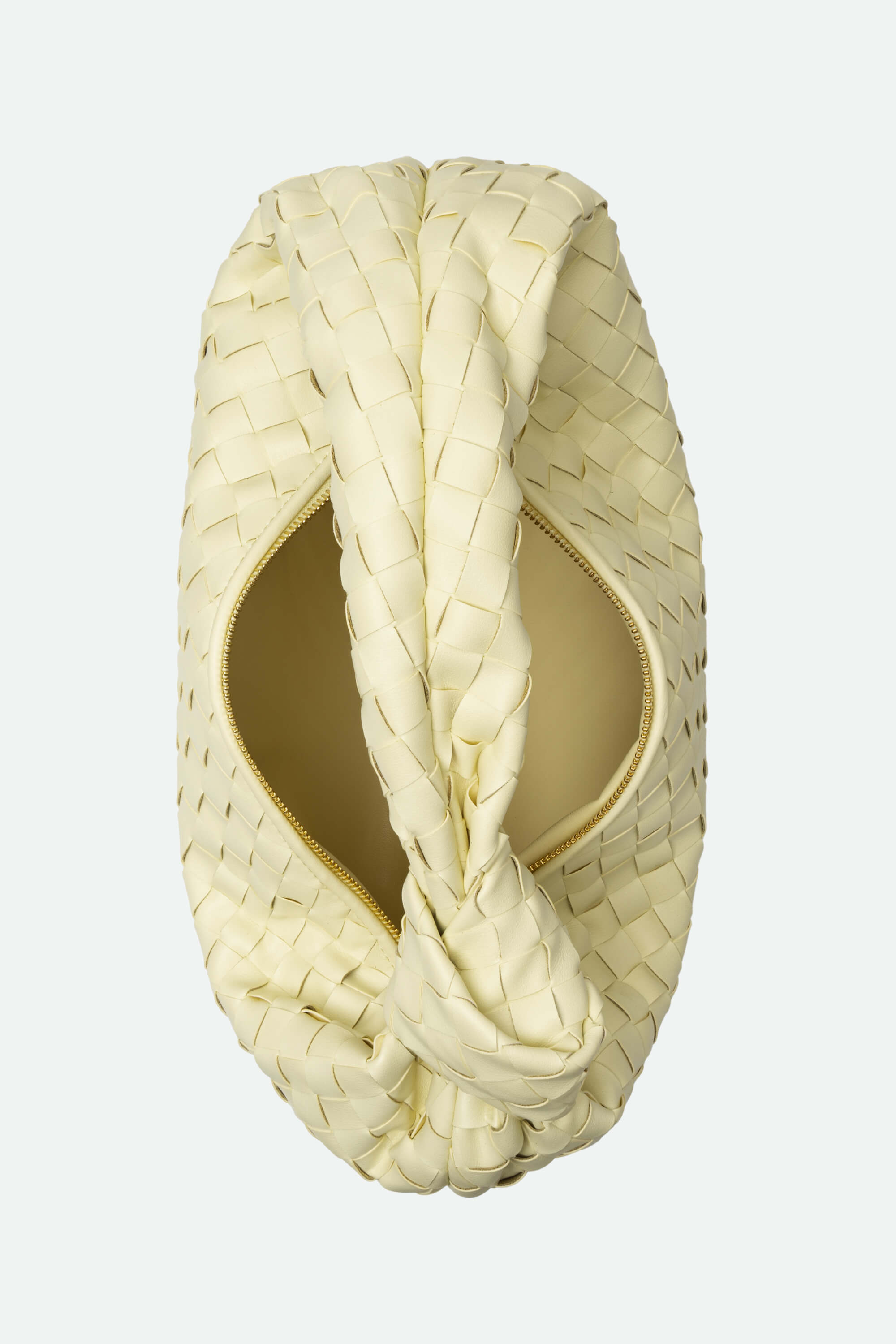 Cream-colored woven clutch bag on a light gray background