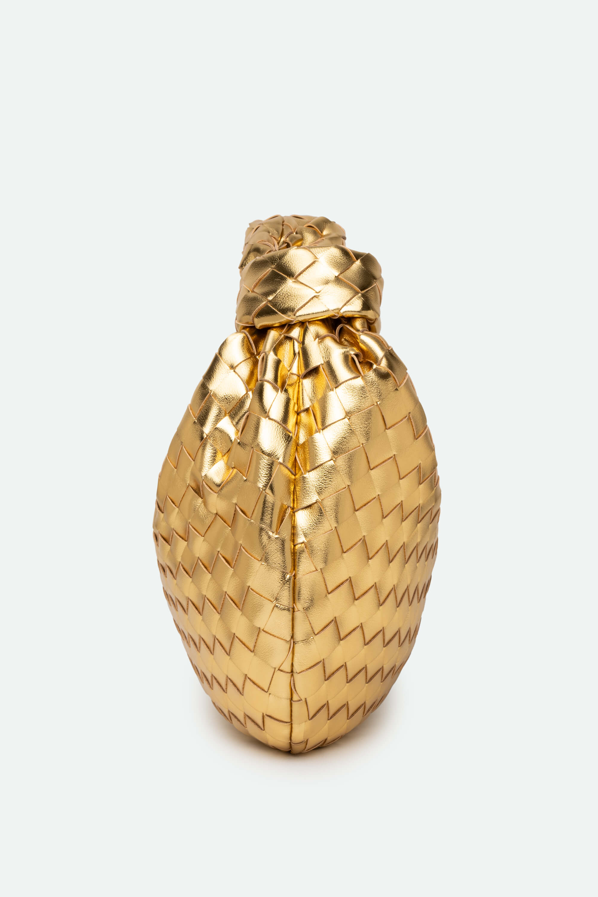 Gold pineapple-shaped bottle on a white background