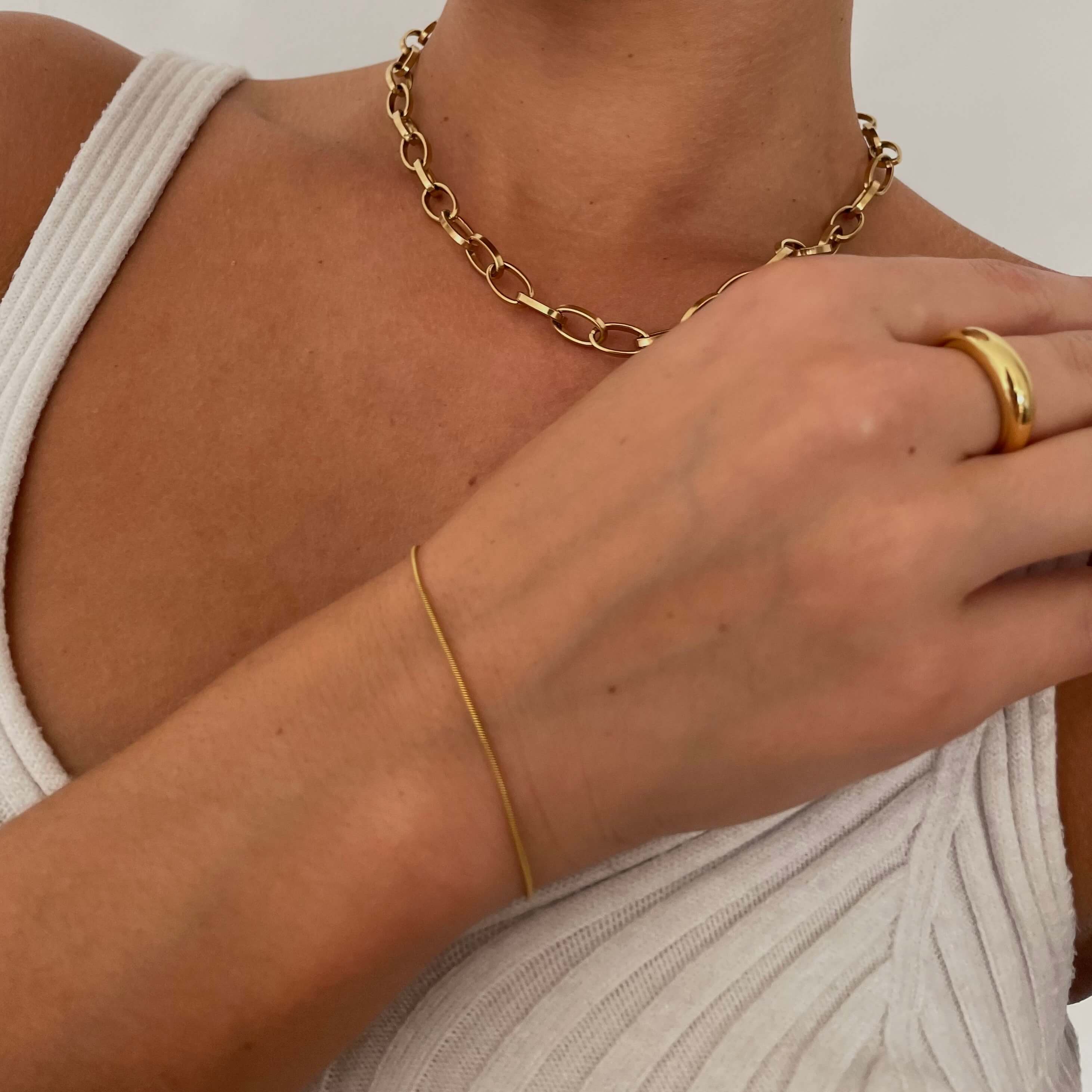 A model wearing gold jewelry and Gold rope bracelet