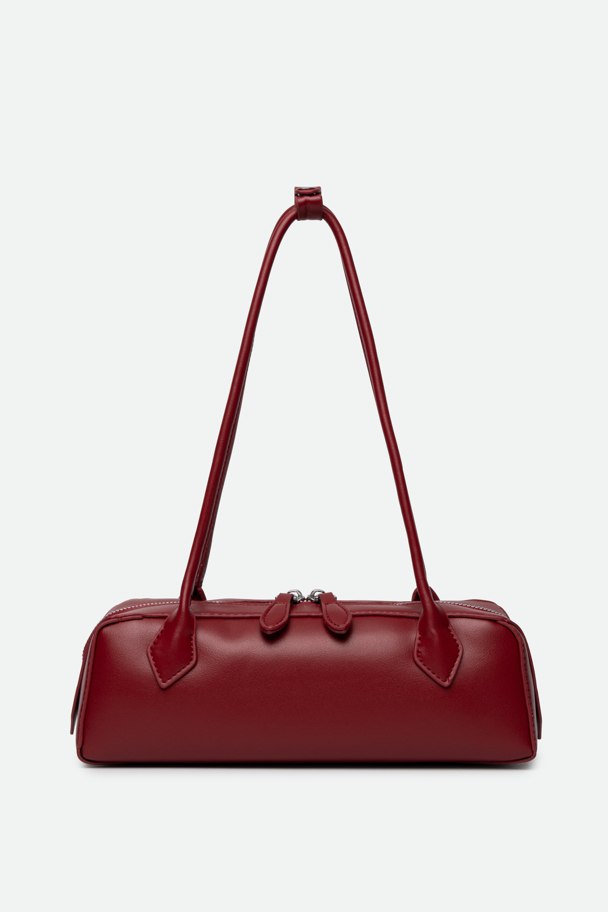 Red handbag with a strap on a white background
