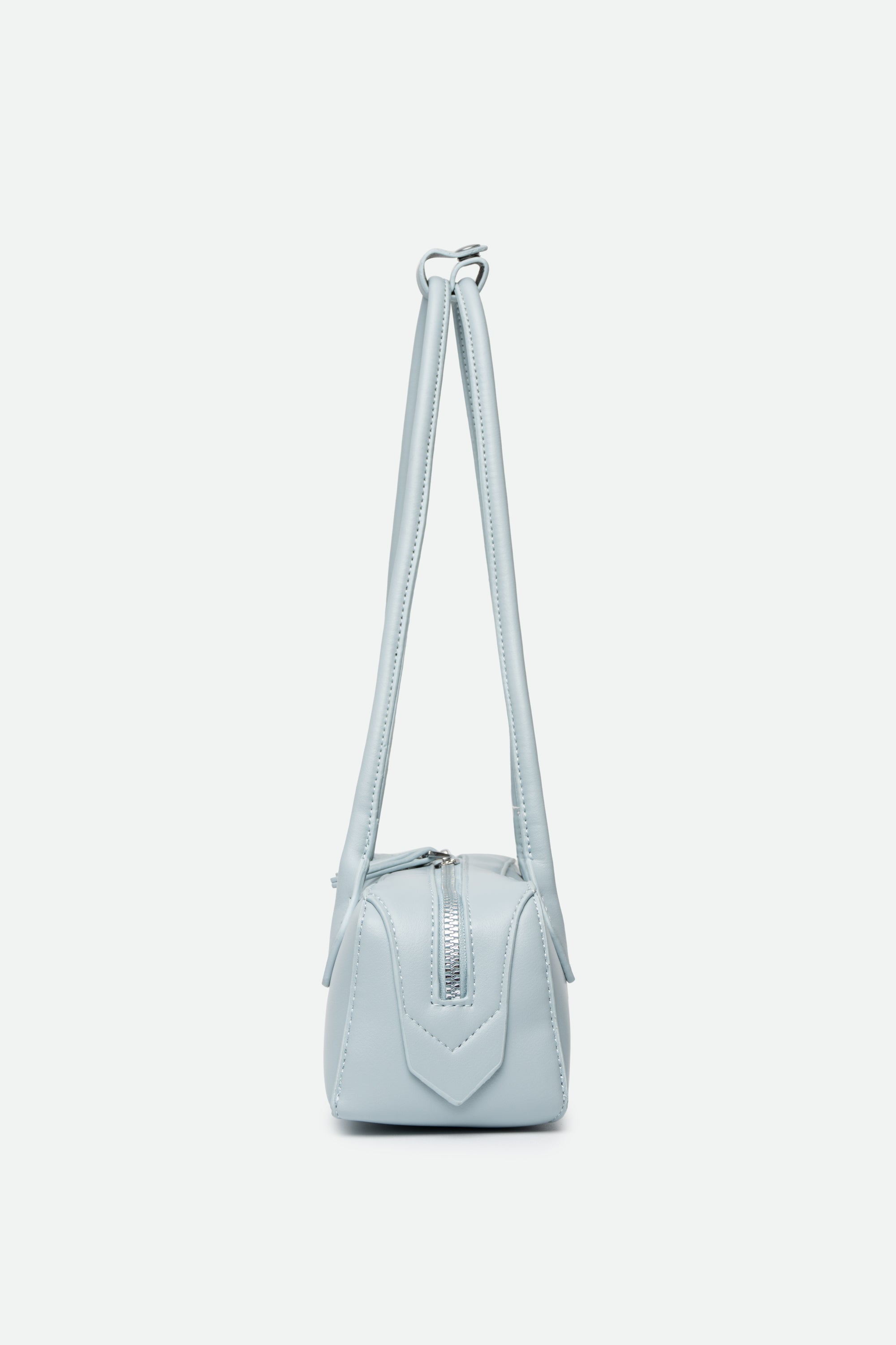Light blue handbag with a strap on a white background