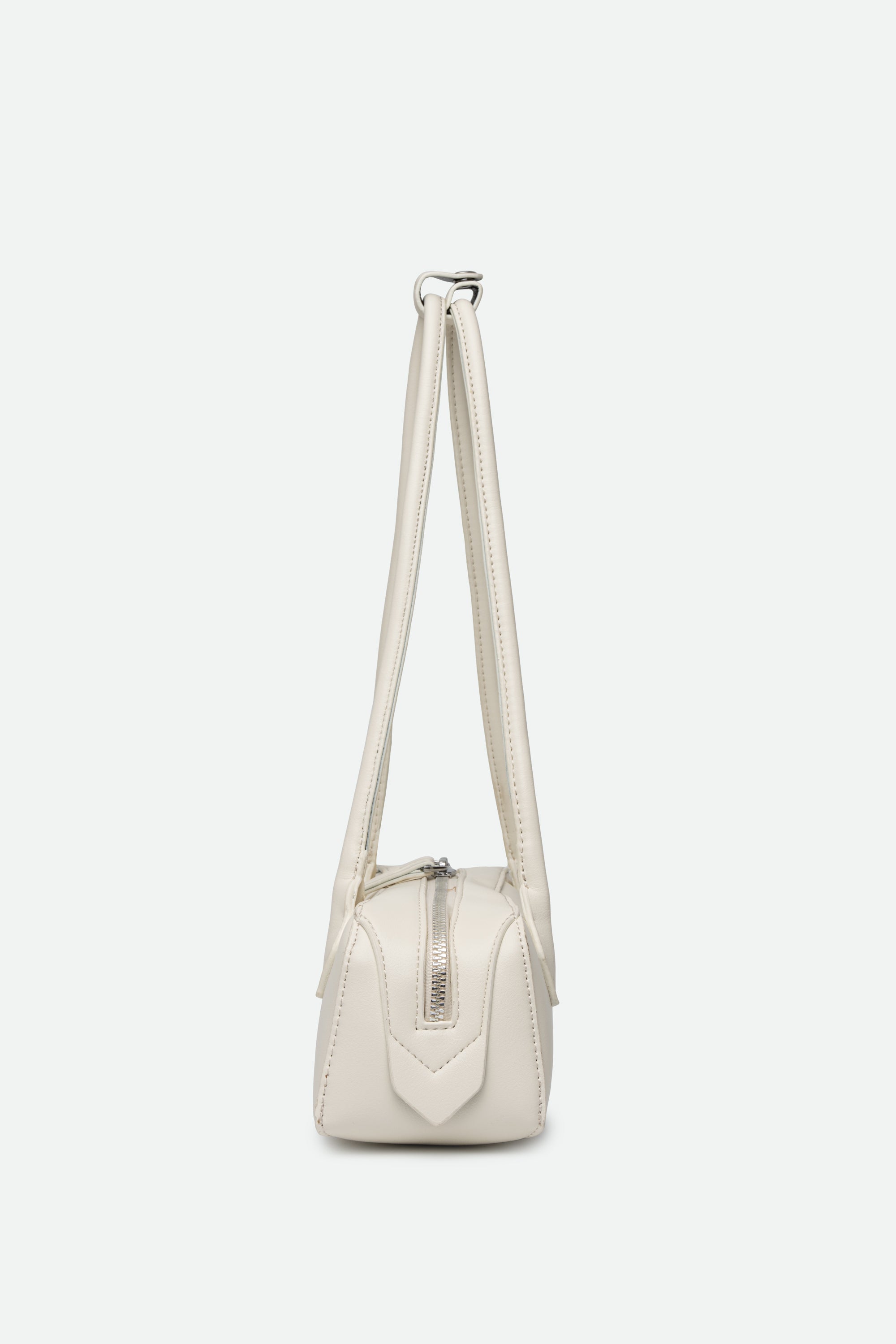 White handbag with a strap on a white background