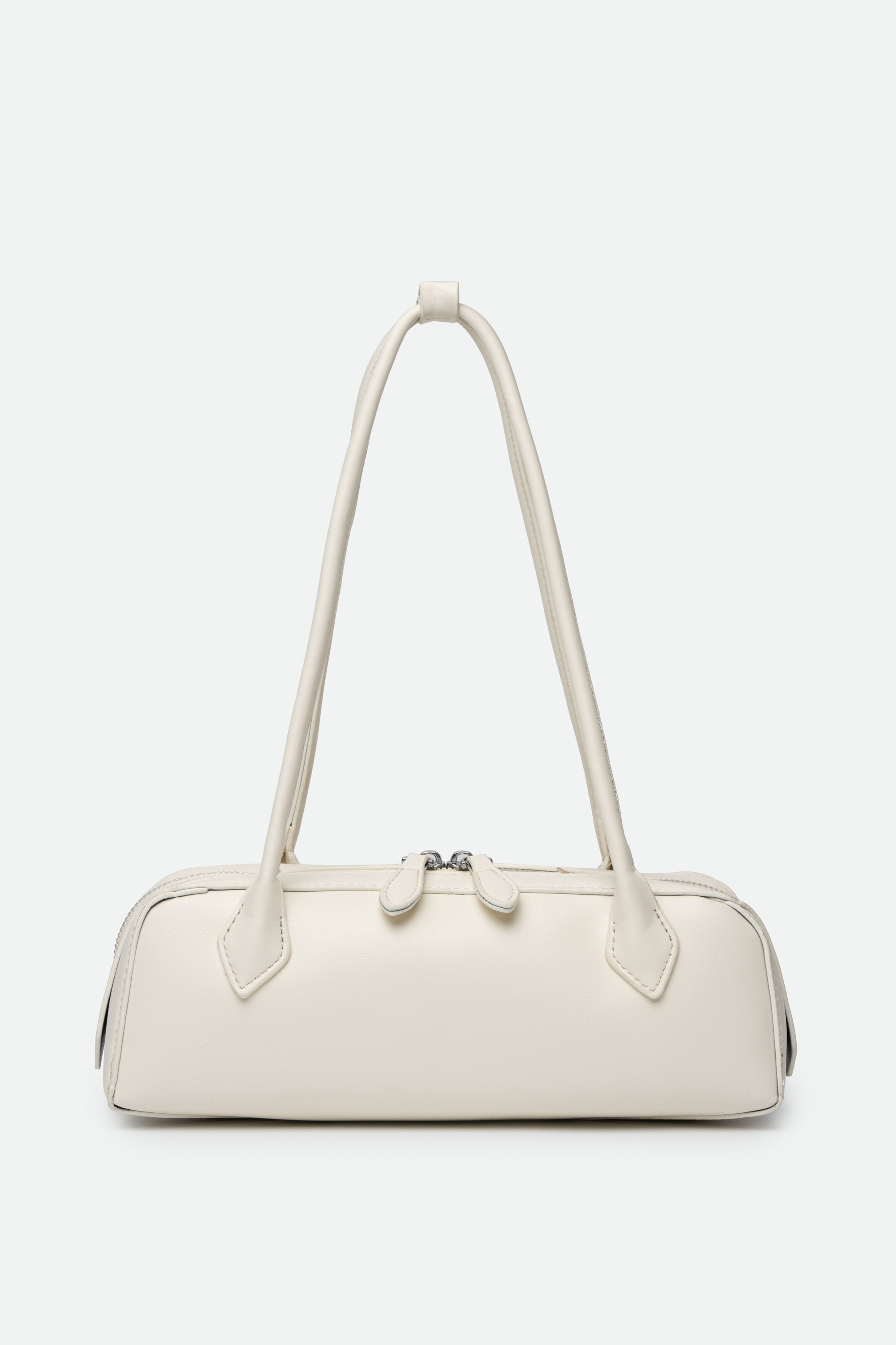 White handbag with a strap on a light gray background