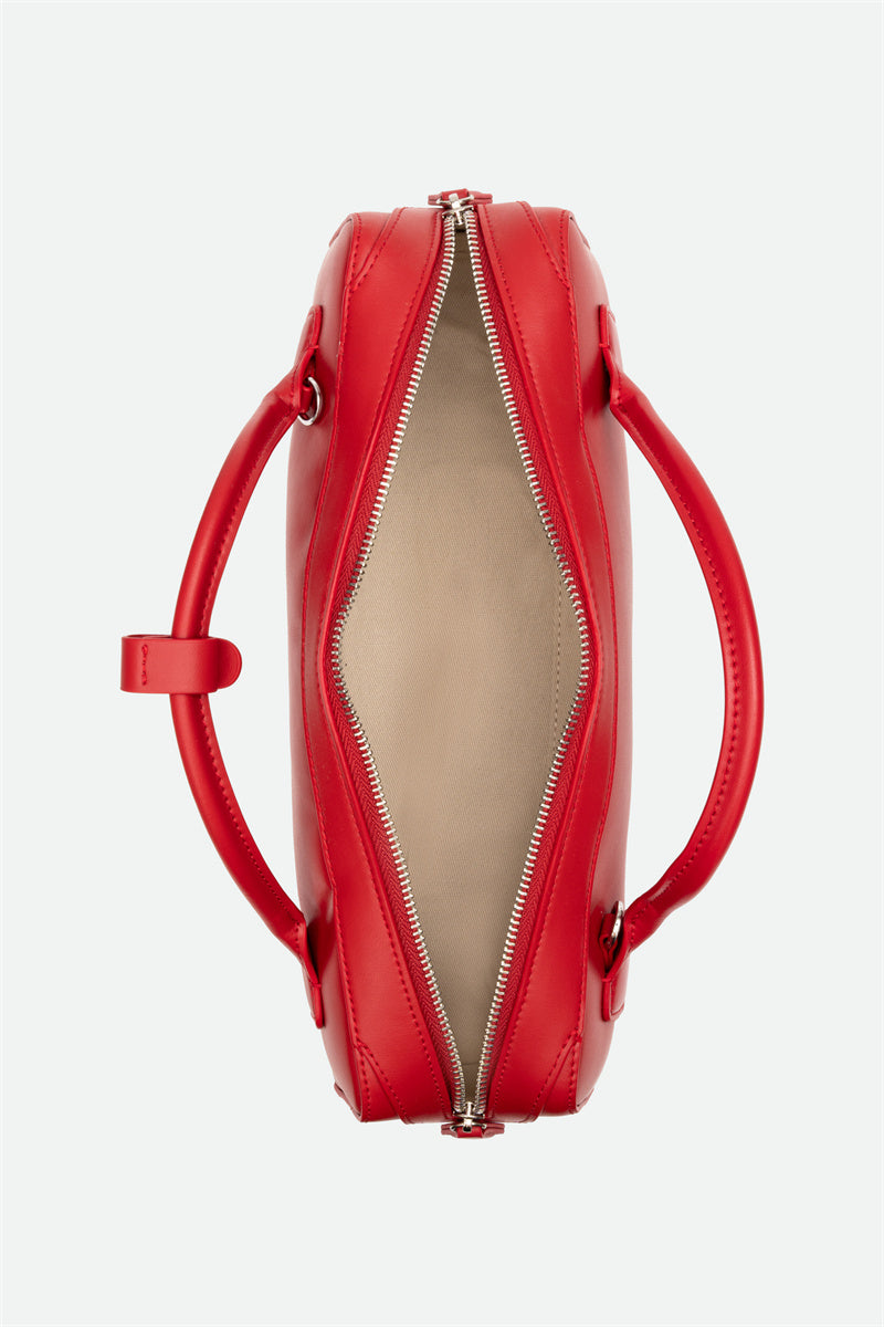 Red handbag with a zipper on a white background
