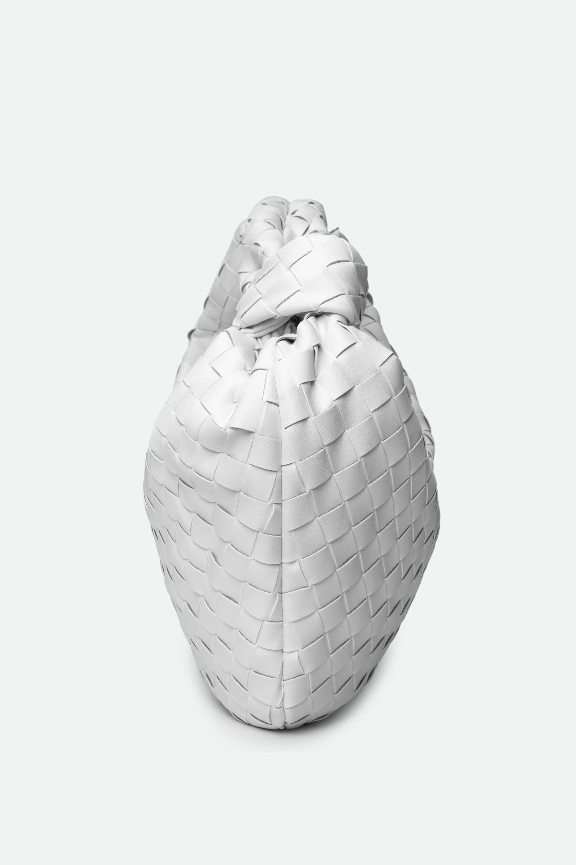 White woven handbag on a light gray background