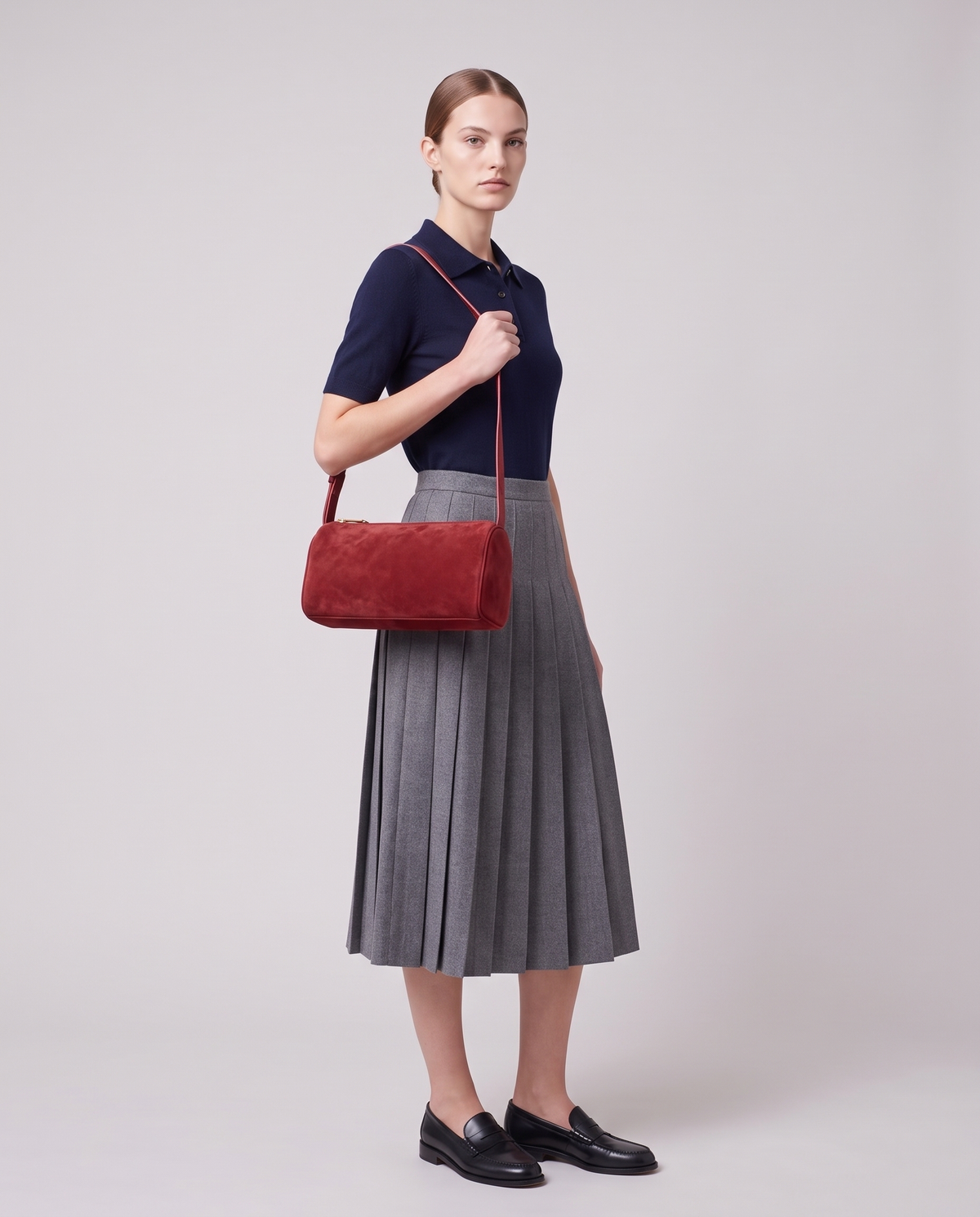 Model carrying the Alba barrel shoulder bag in Red suede on the shoulder