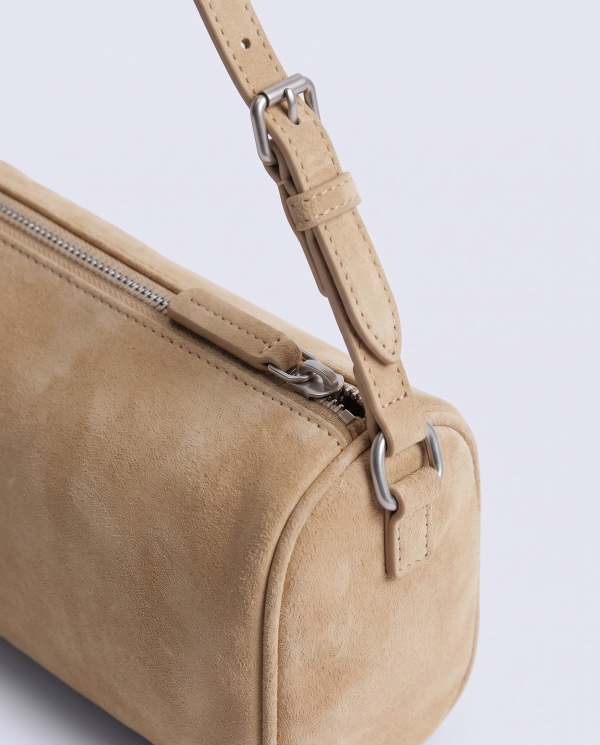 Alba barrel shoulder bag in Beige suede – silver buckle and zip hardware detail