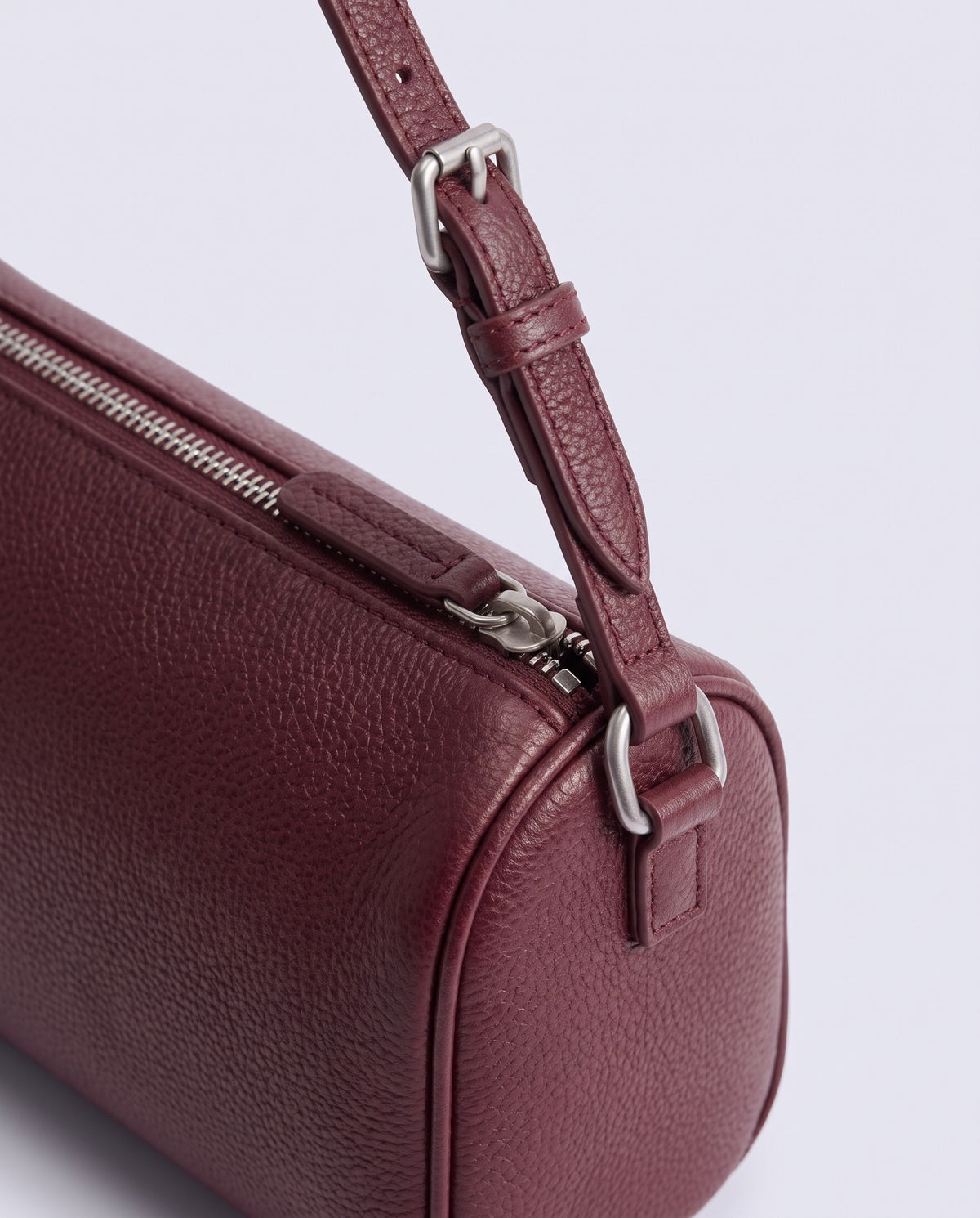 Alba barrel shoulder bag in Burgundy leather – silver buckle and zip hardware detail