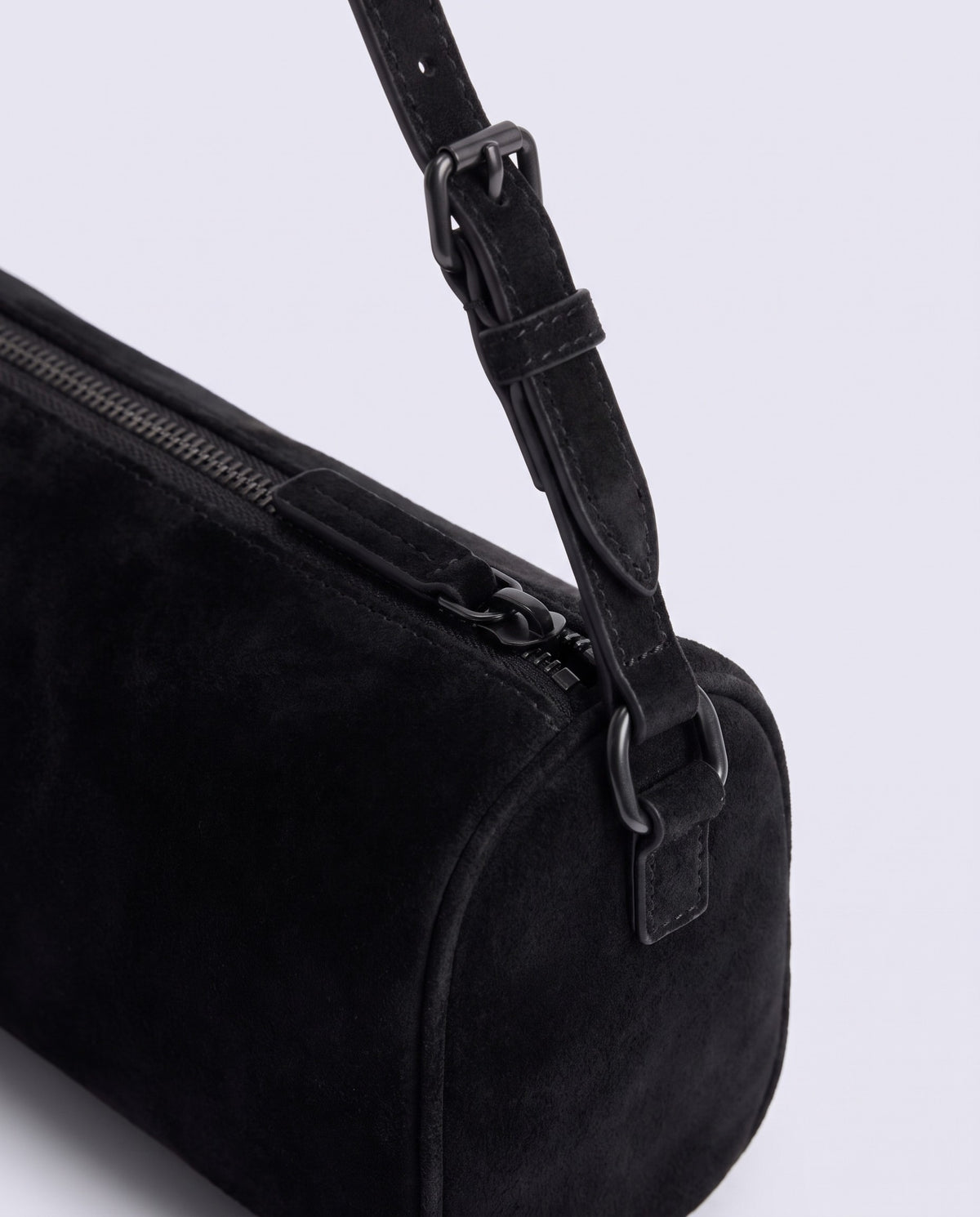 Alba barrel shoulder bag in Onyx black suede – dark buckle and zip hardware detail