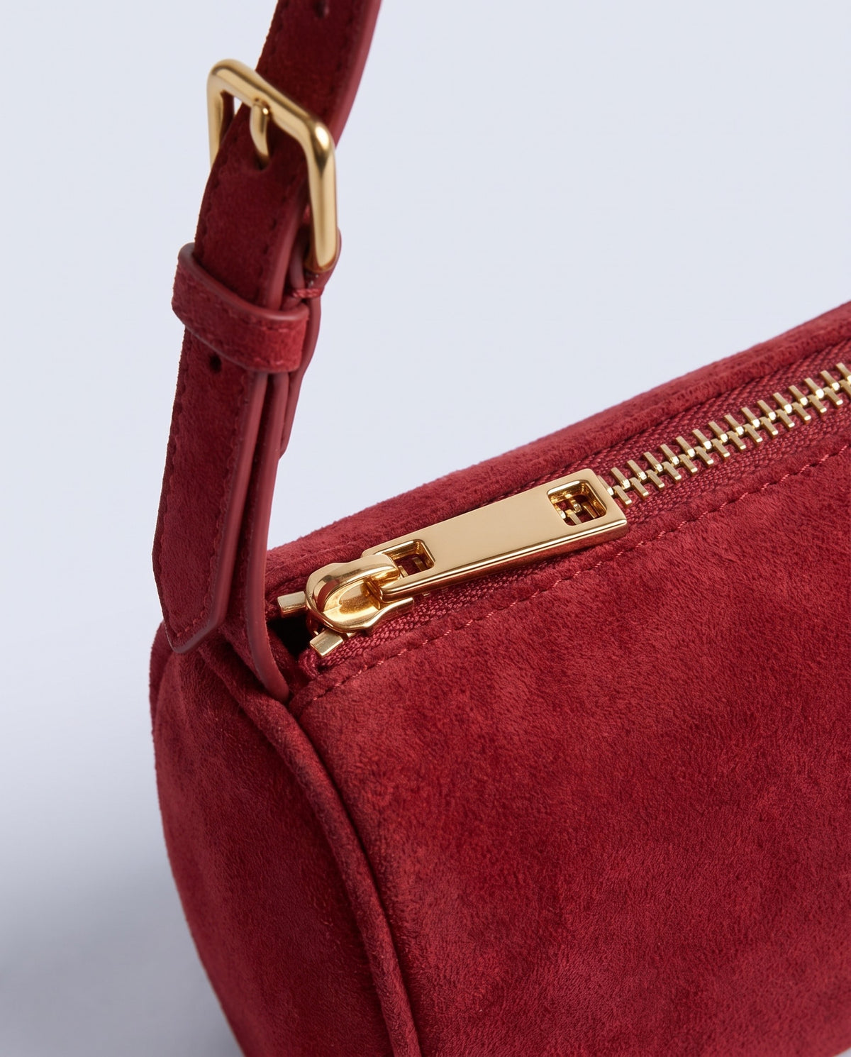 Alba barrel shoulder bag in Red suede – gold buckle and zip hardware detail