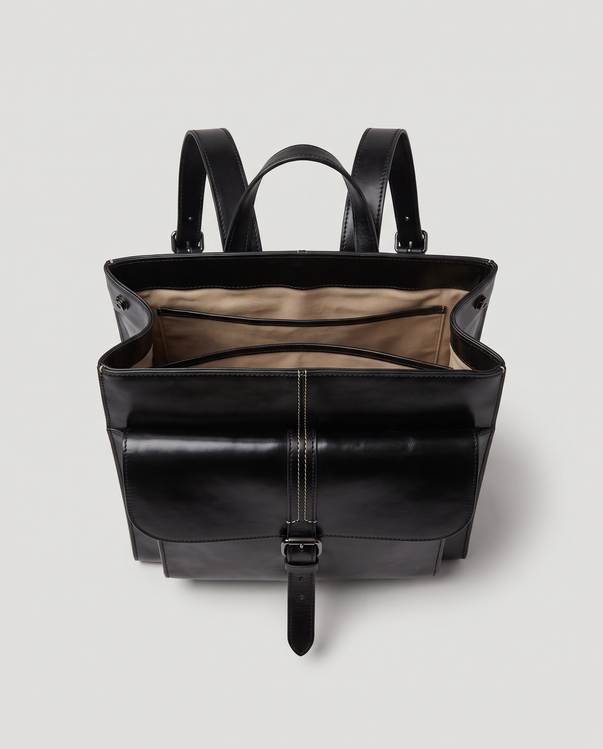 Ambler waxed leather backpack in Black – flap open, showing the lined interior