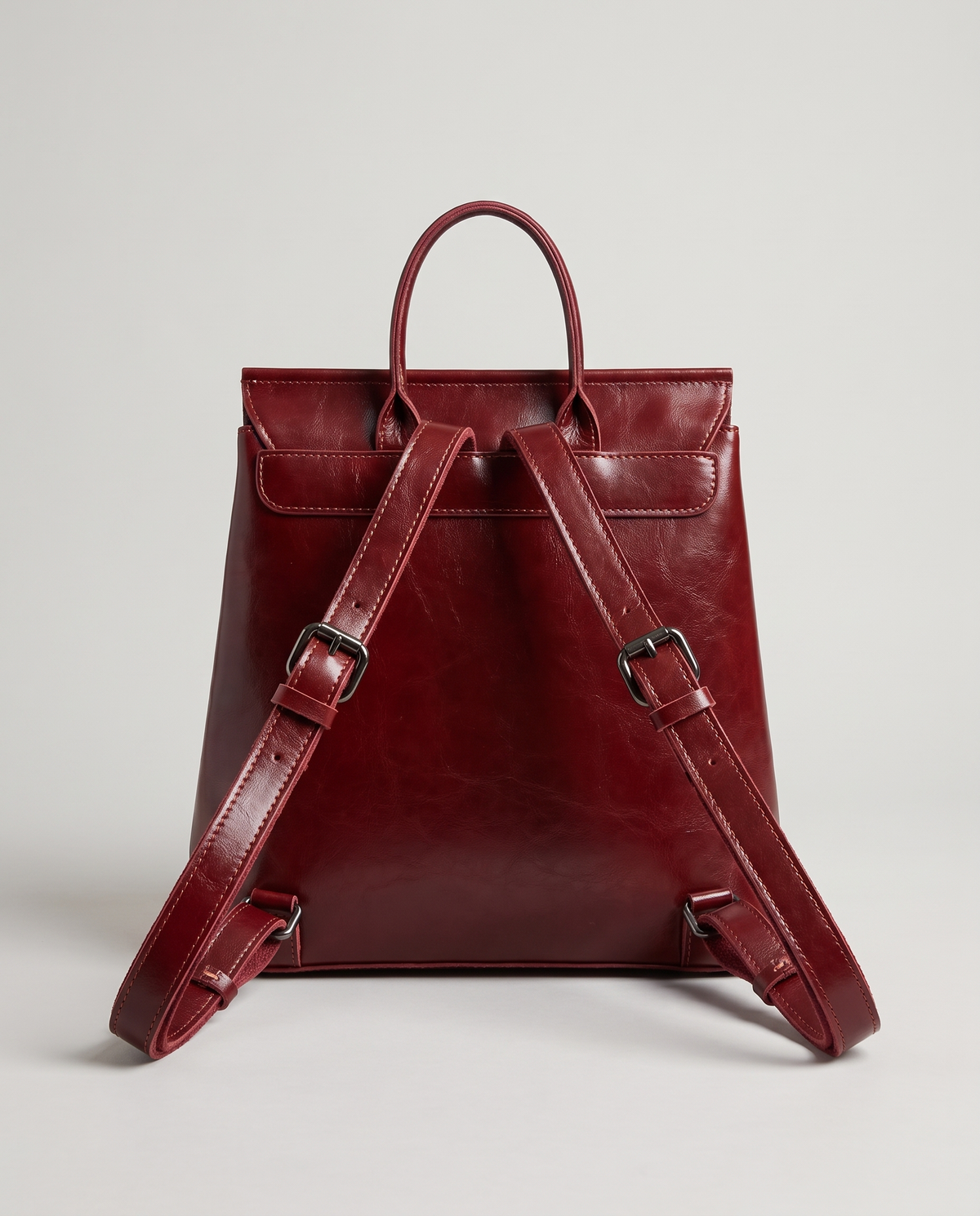 Ambler waxed leather backpack in Red – back view showing the shoulder straps