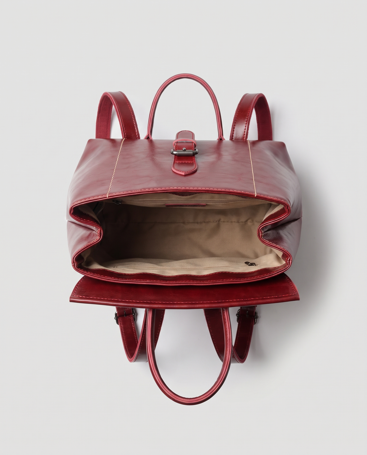 Ambler waxed leather backpack in Red – flap open, showing the lined interior