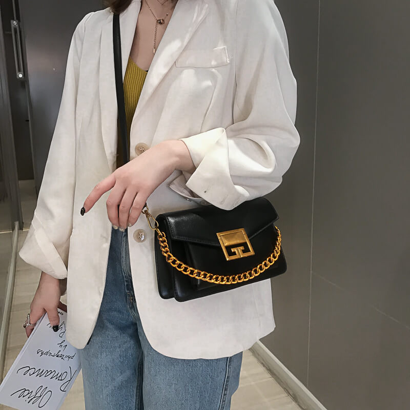 Woman carrying Givenchy gv3 crossbody bag black