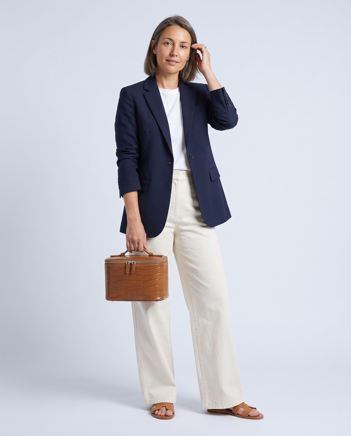 Model holding the Bellagio vanity case in Cognac – full-length view