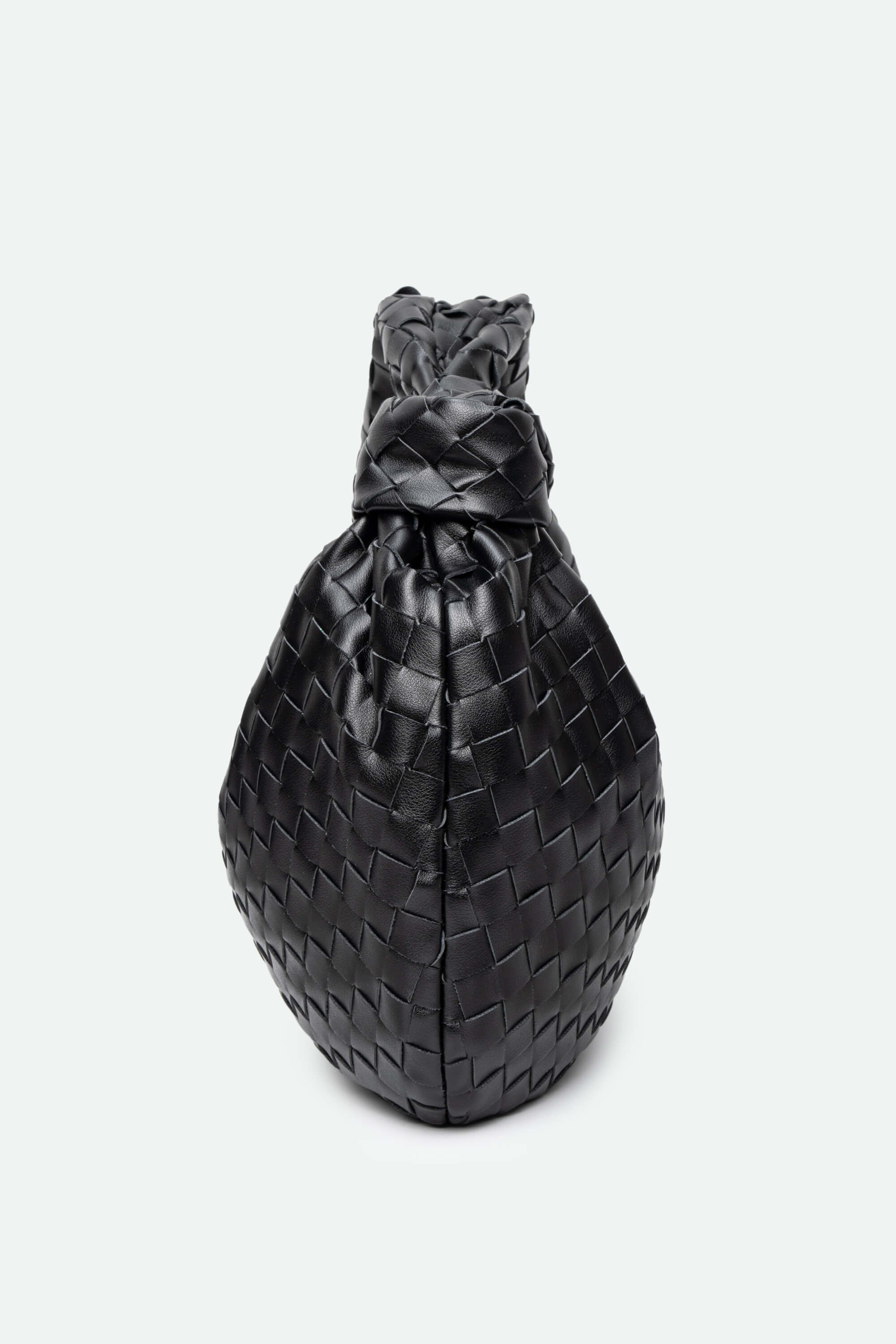 Black woven handbag on a light gray background