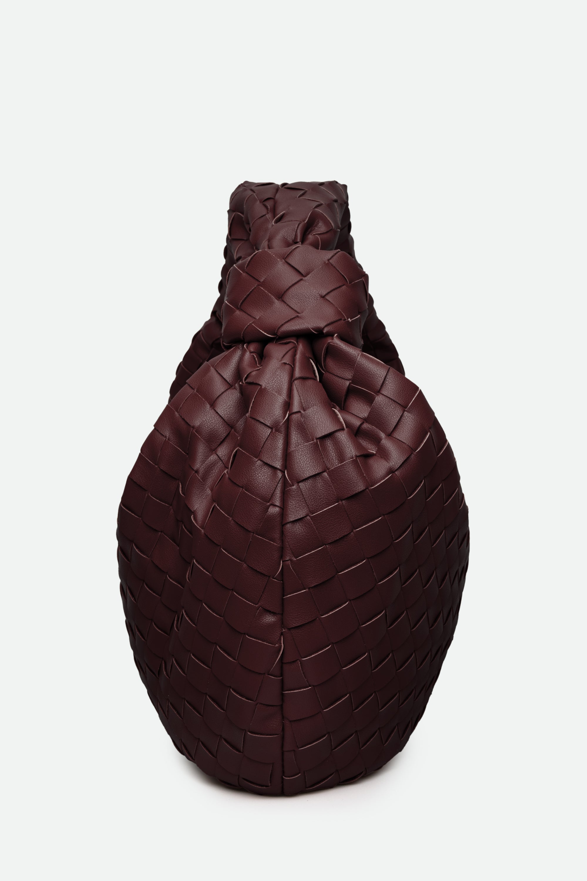 Brown woven handbag on a white background