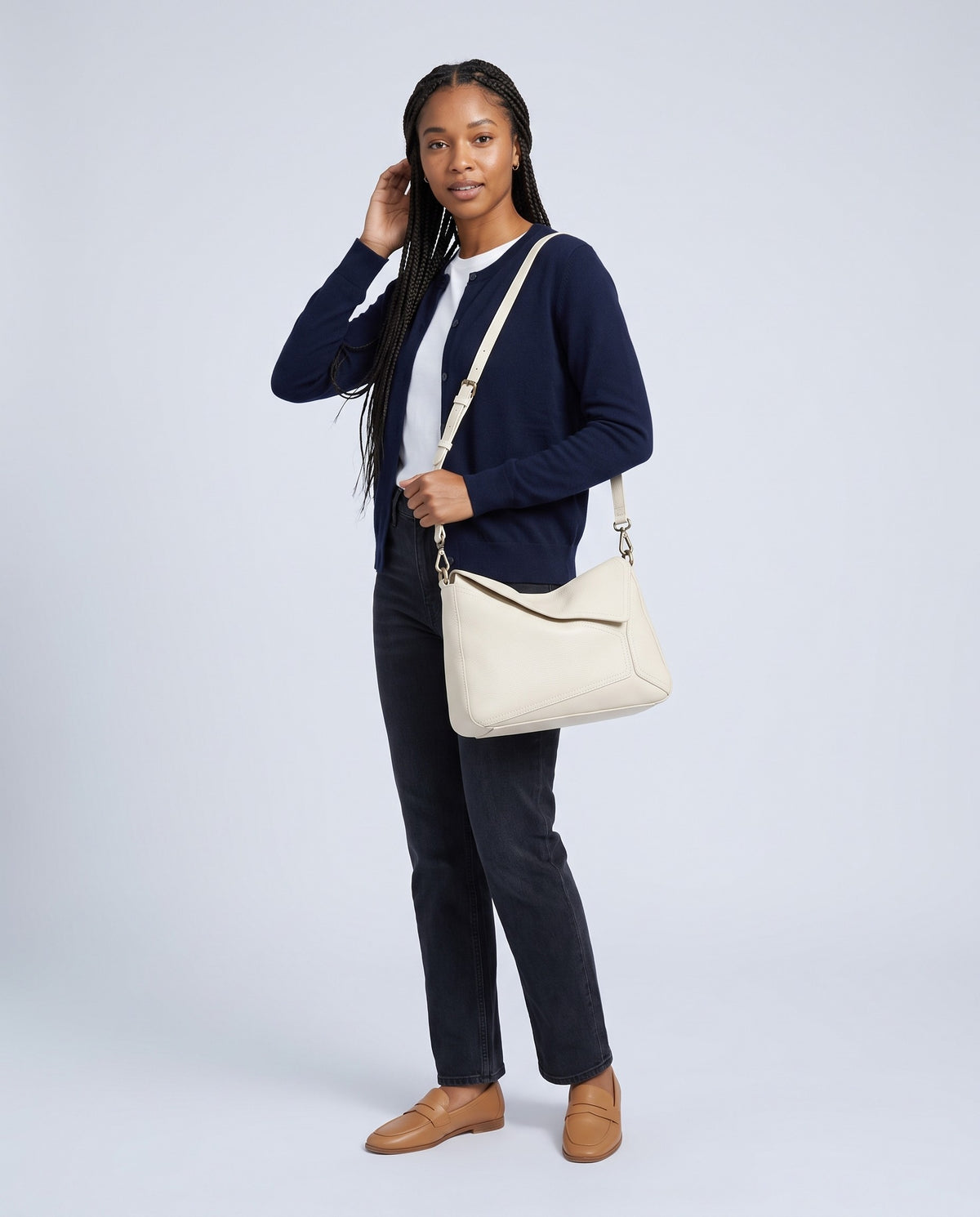 Model wearing the Camogli shoulder bag in Ivory – full-length view