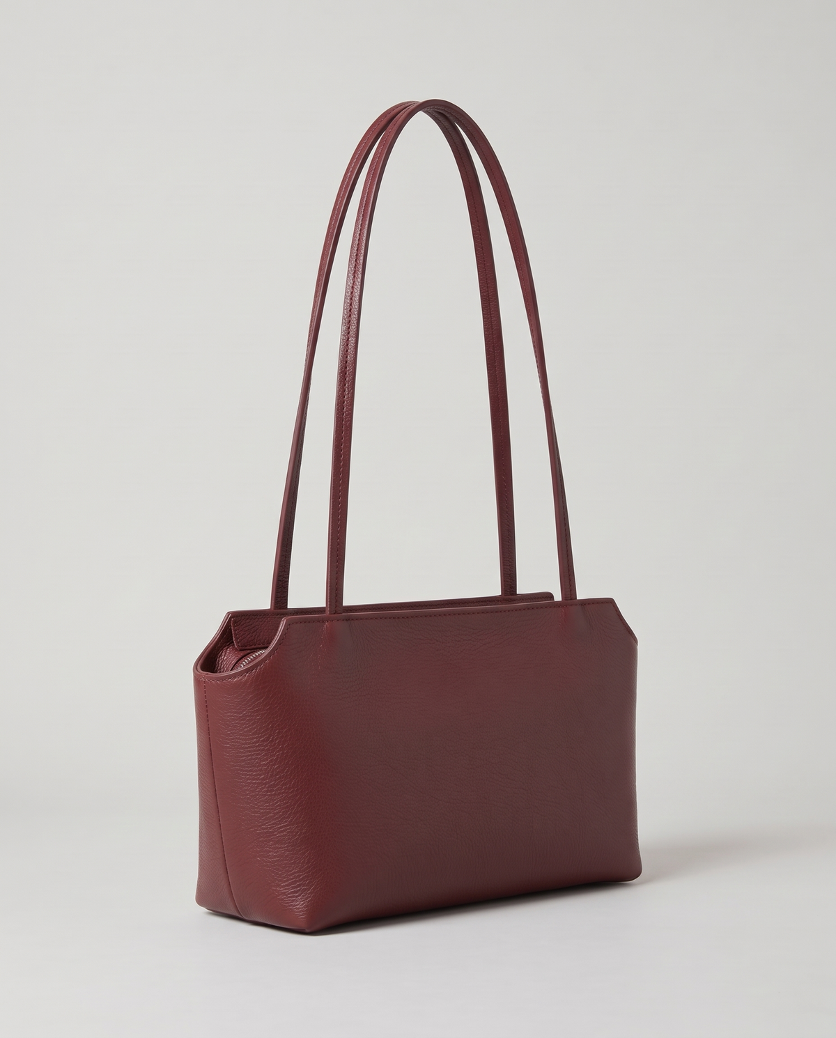 Capri leather shoulder bag in burgundy, three-quarter view