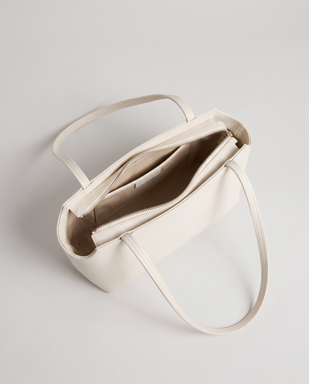 Capri leather shoulder bag in white, open showing interior