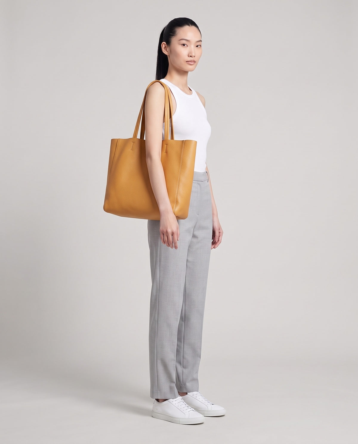Model with the Costa leather tote in camel, full length