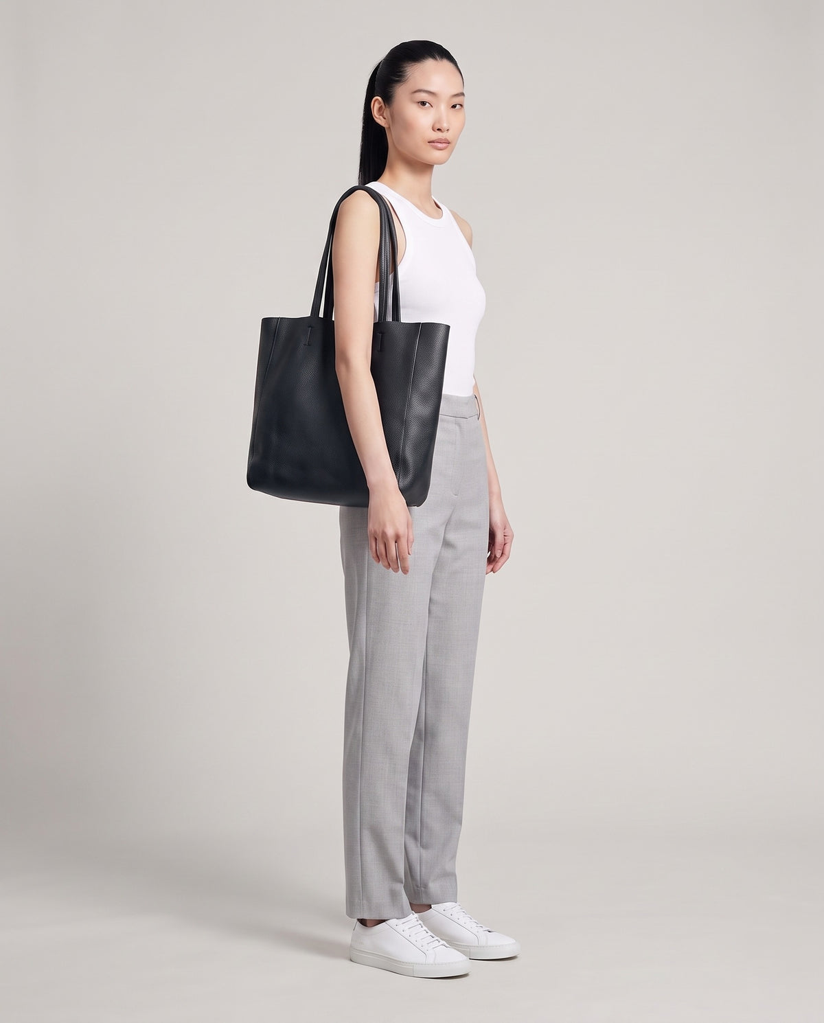 Model with the Costa leather tote in onyx, full length