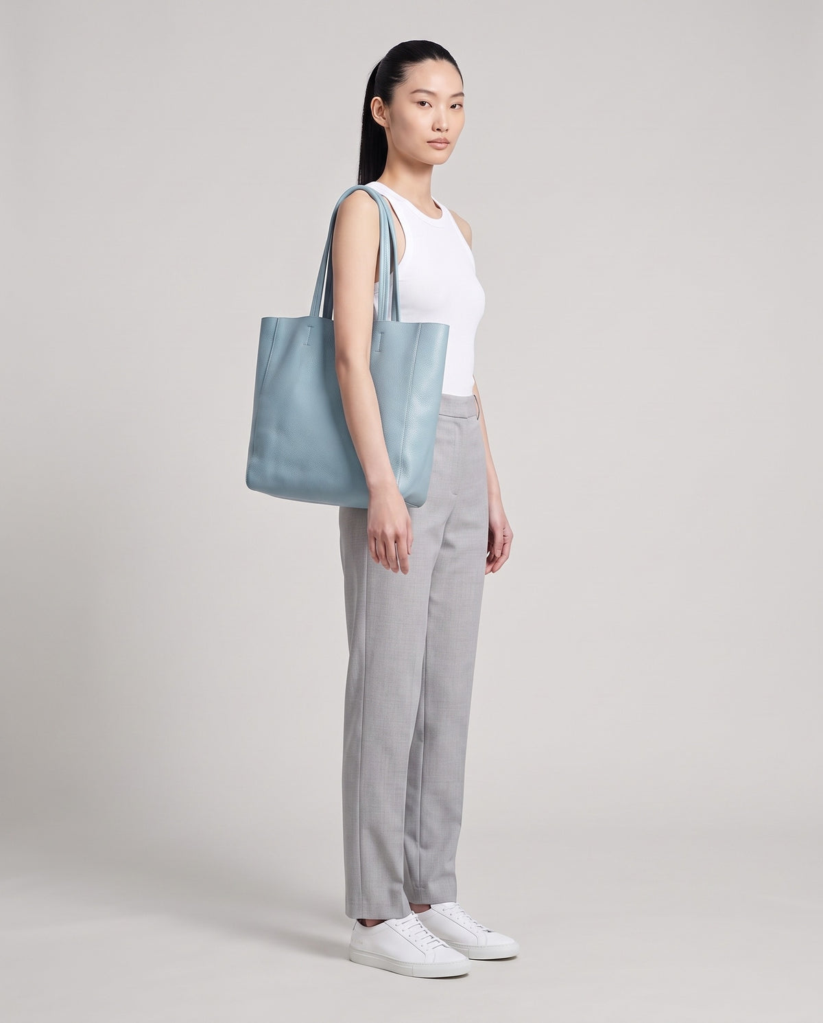 Model with the Costa leather tote in sky, full length
