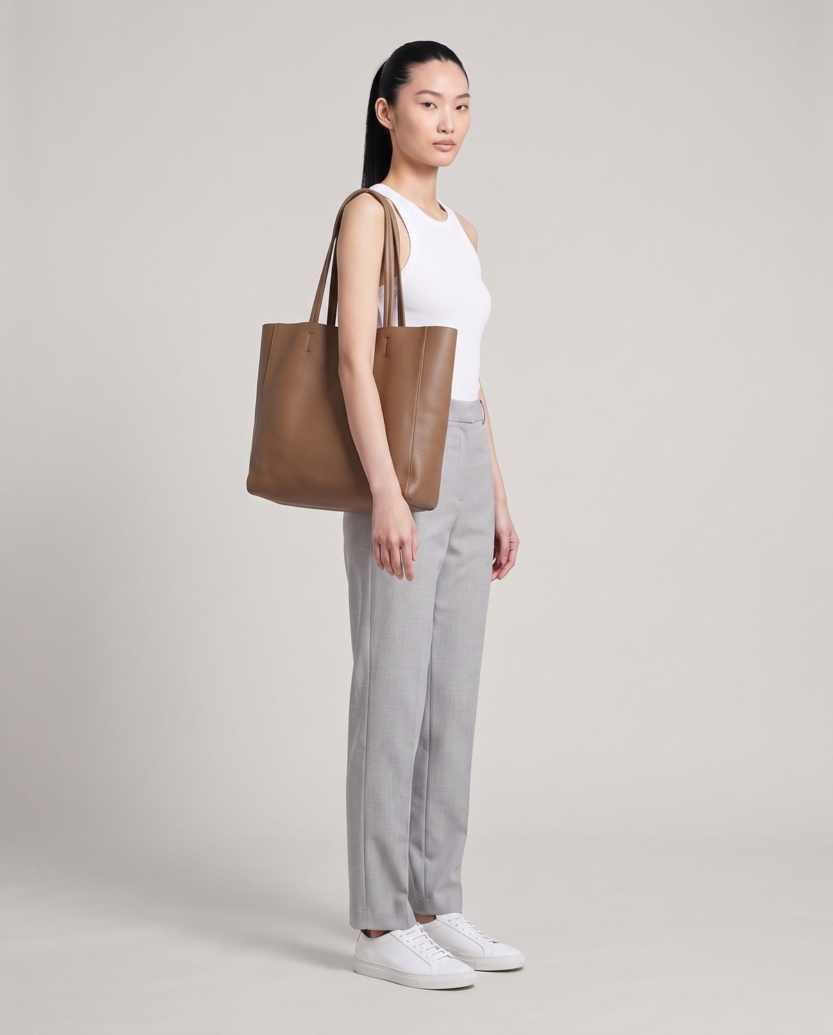 Model with the Costa leather tote in taupe, full length