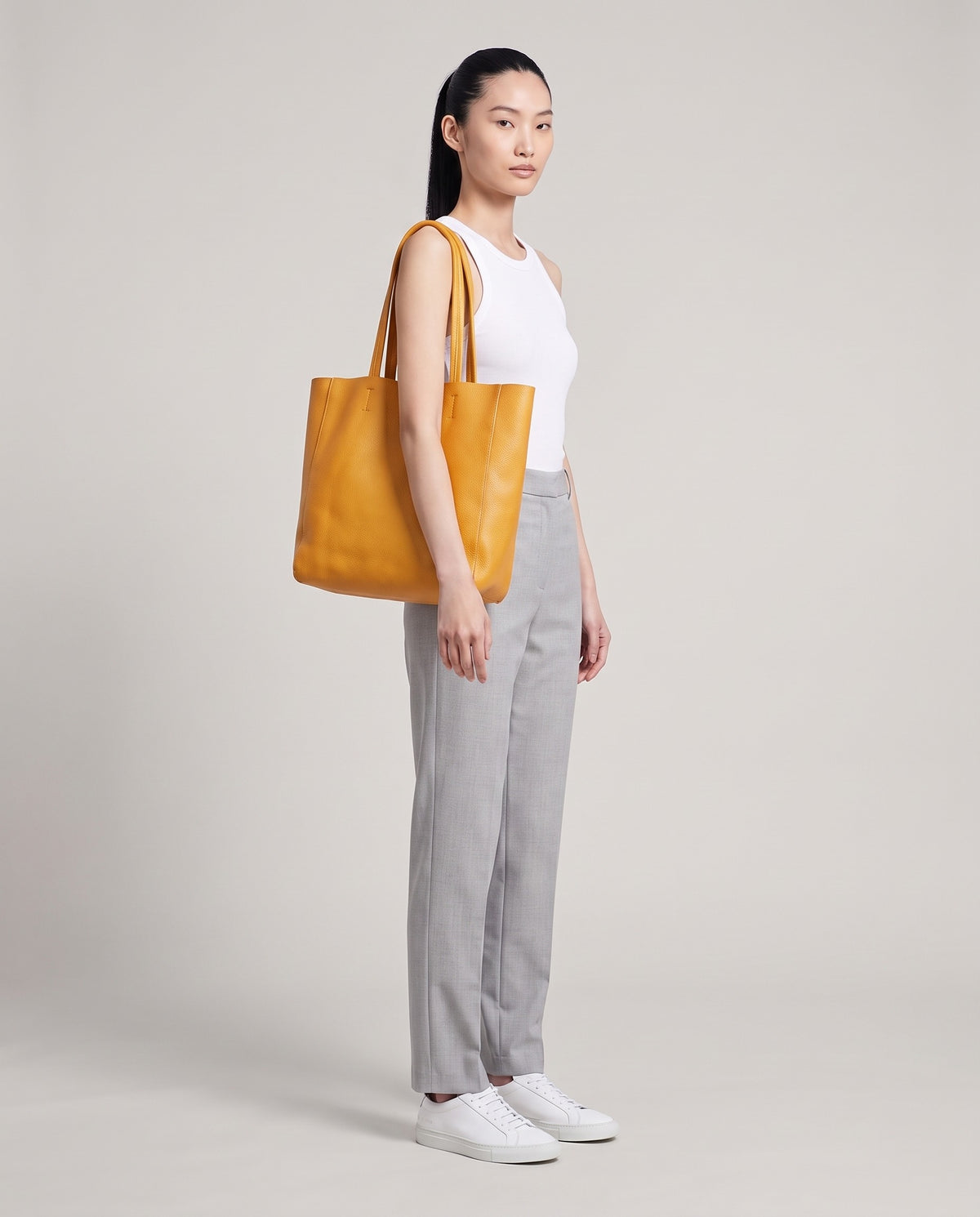 Model with the Costa leather tote in yellow, full length