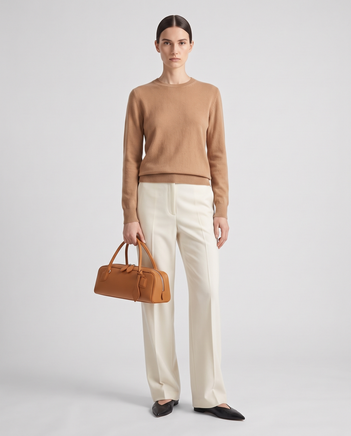 Curve leather barrel bag in Caramel – model holding it, full length