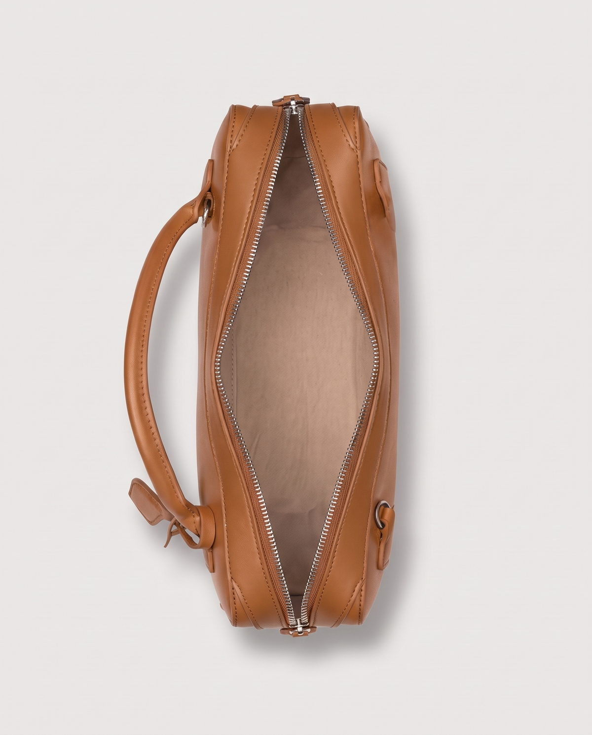Curve leather barrel bag in Caramel – inside view with the zip open