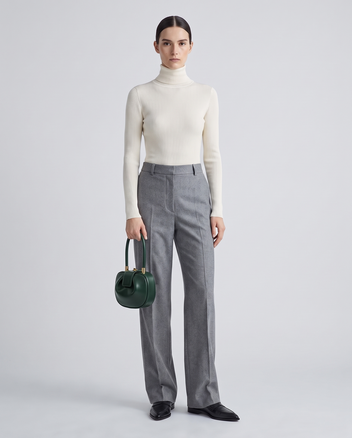Dumpling Mini leather top-handle bag in Green – model holding it, full length
