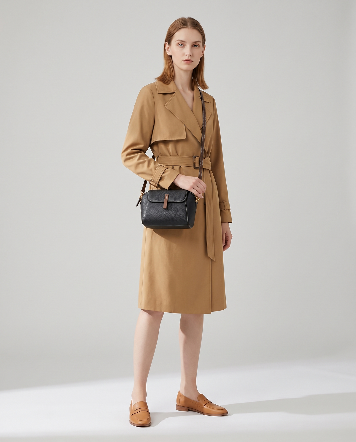 Elara mini leather crossbody in Black – model wearing it crossbody, full length
