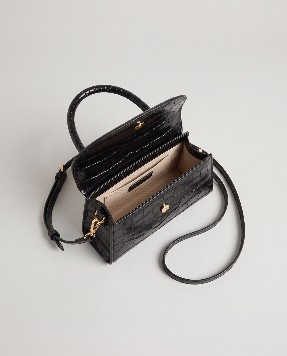 Fern mini croc top-handle bag in Black – flap open, showing the lined interior