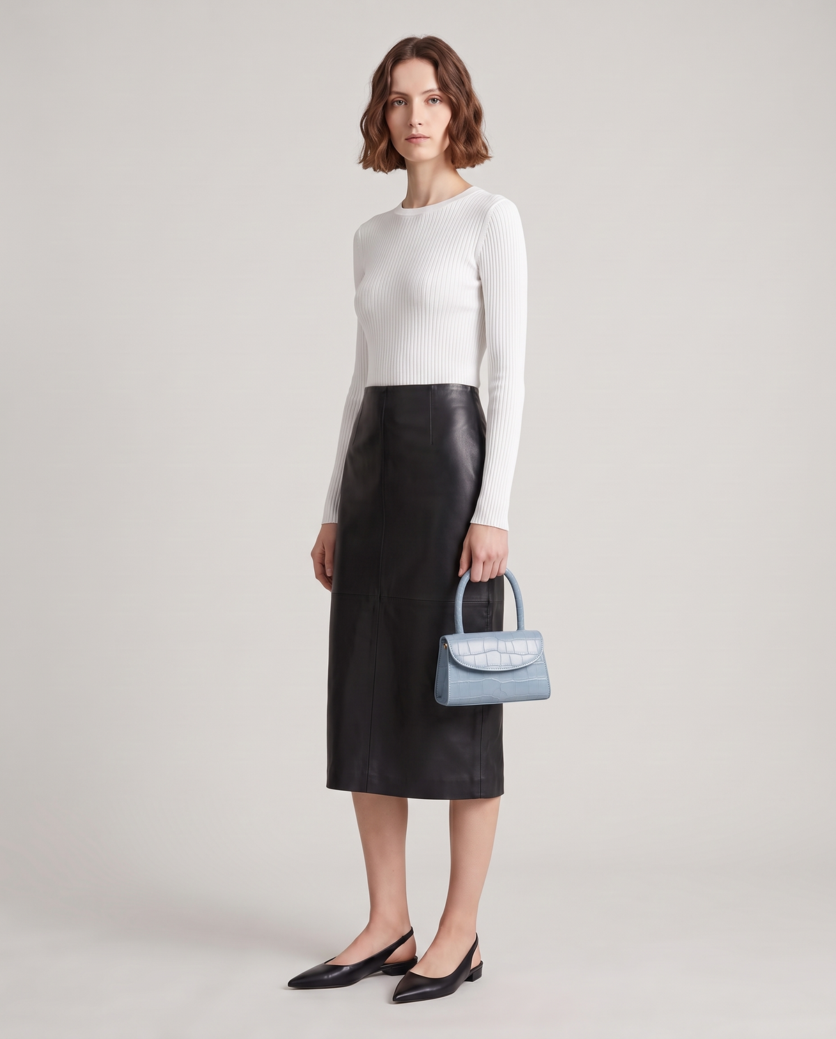Fern mini croc top-handle bag in Blue – model holding it by the top handle, full length