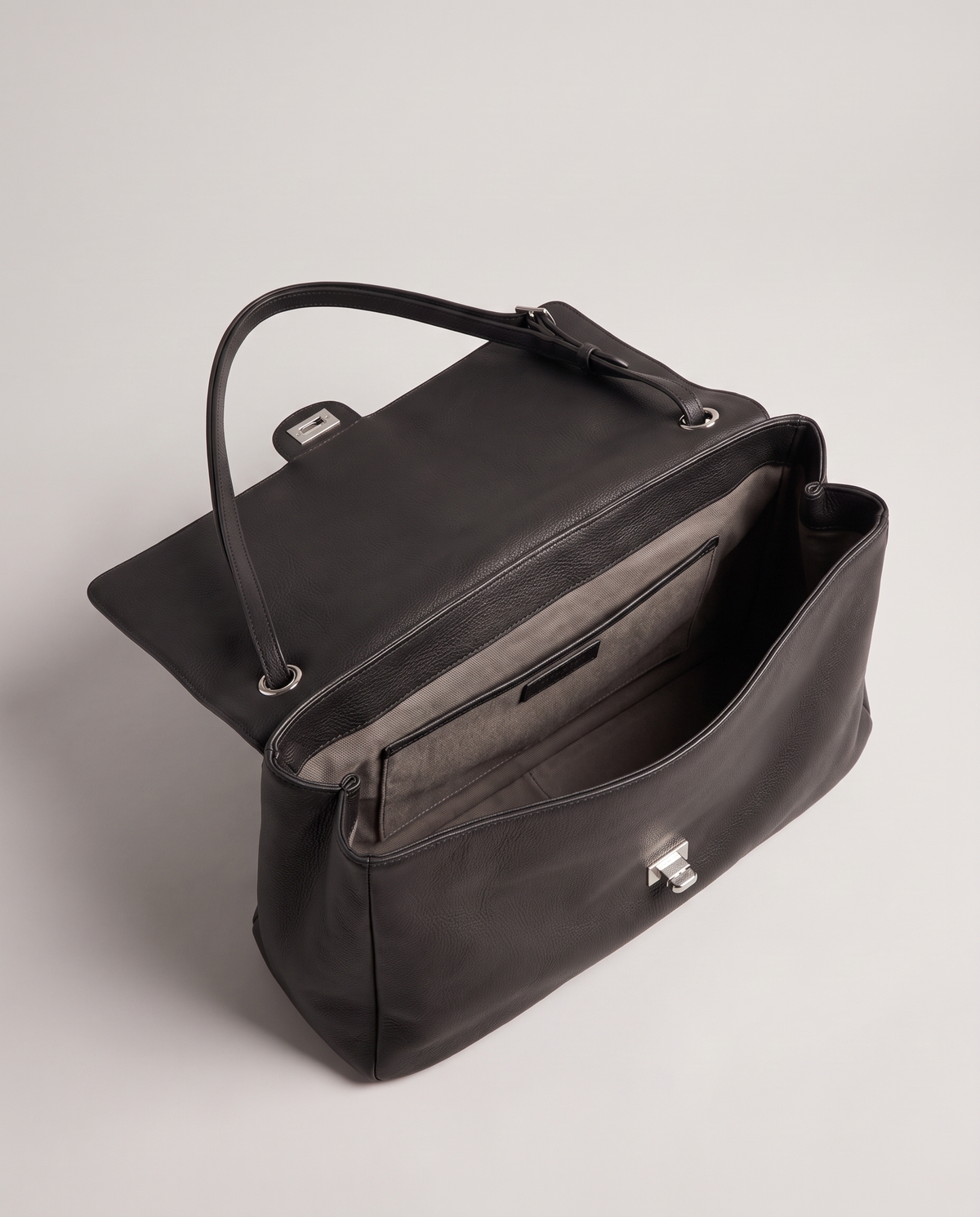 Fiume leather shoulder bag in black, open showing interior