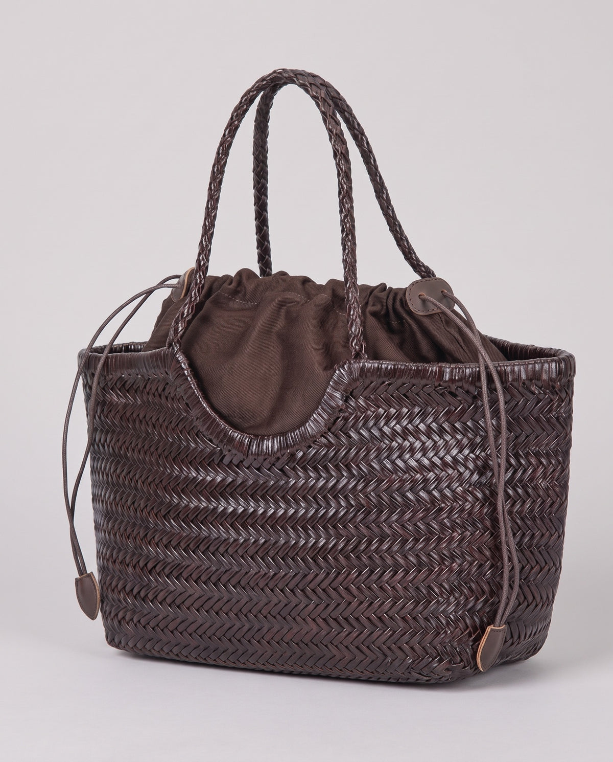 Hardware and handle detail on the Valentina Gubbio bag in Chocolate