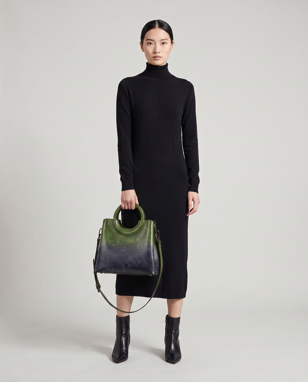 Ombra hand-painted ombré leather bag in Green – model holding it by the ring handles, full length