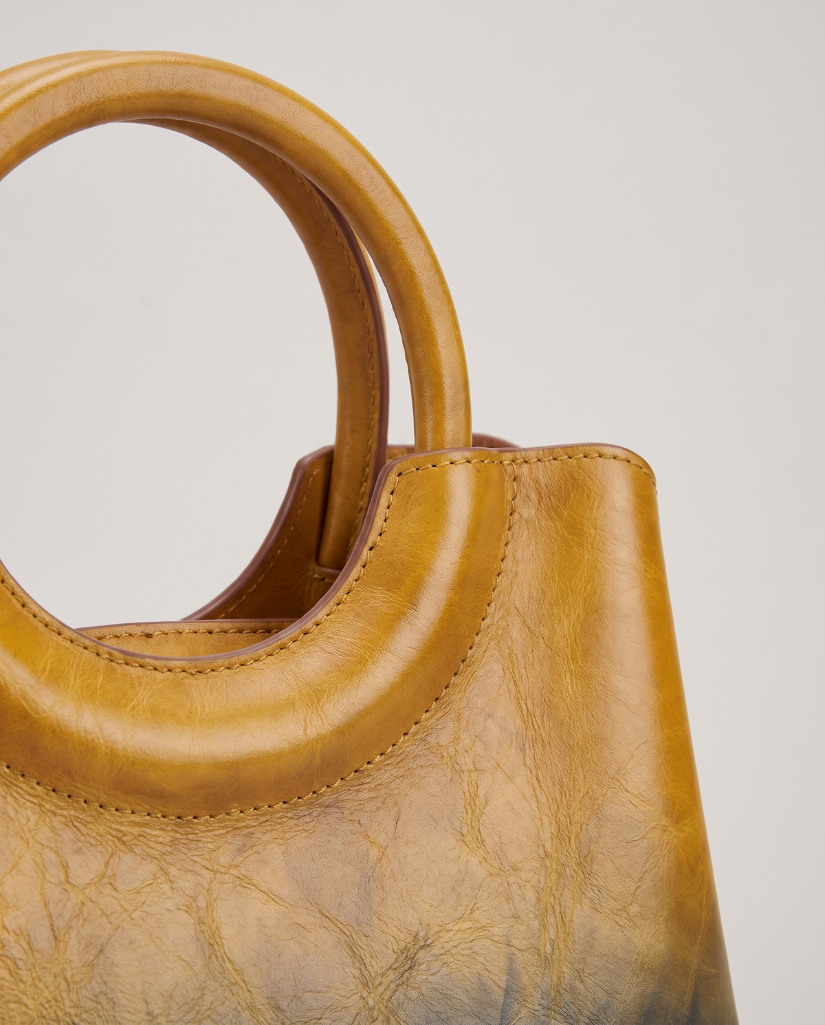 Ombra hand-painted ombré leather bag in Yellow – close-up of the ring handle and hand-painted ombré finish