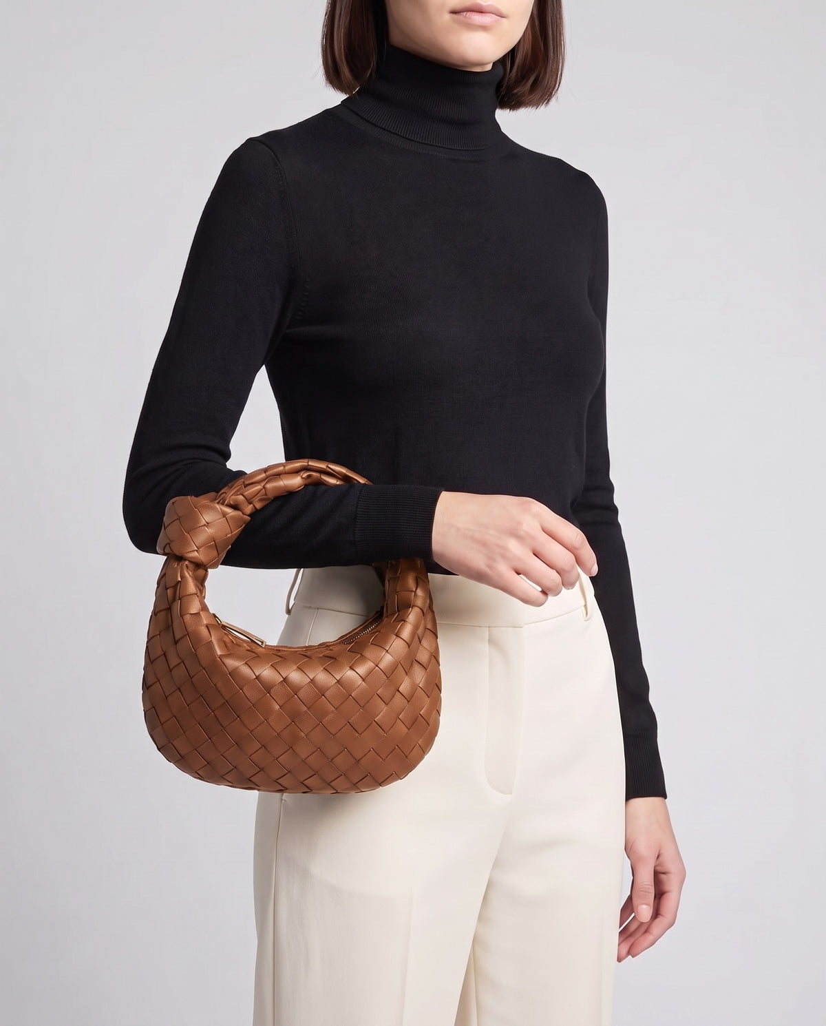 Knot Midi woven leather bag in Brown – model carrying it