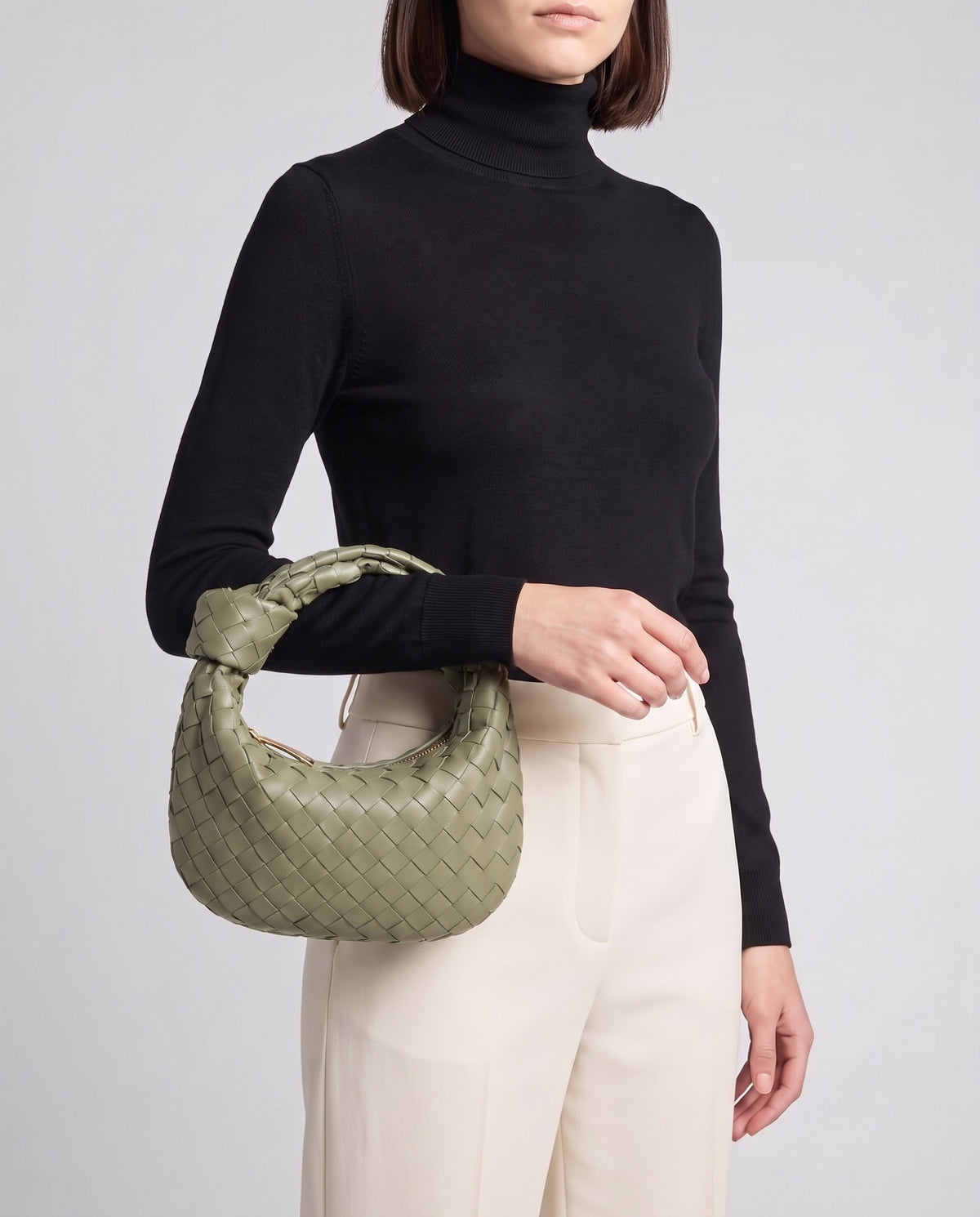Knot Midi woven leather bag in Sage – model carrying it