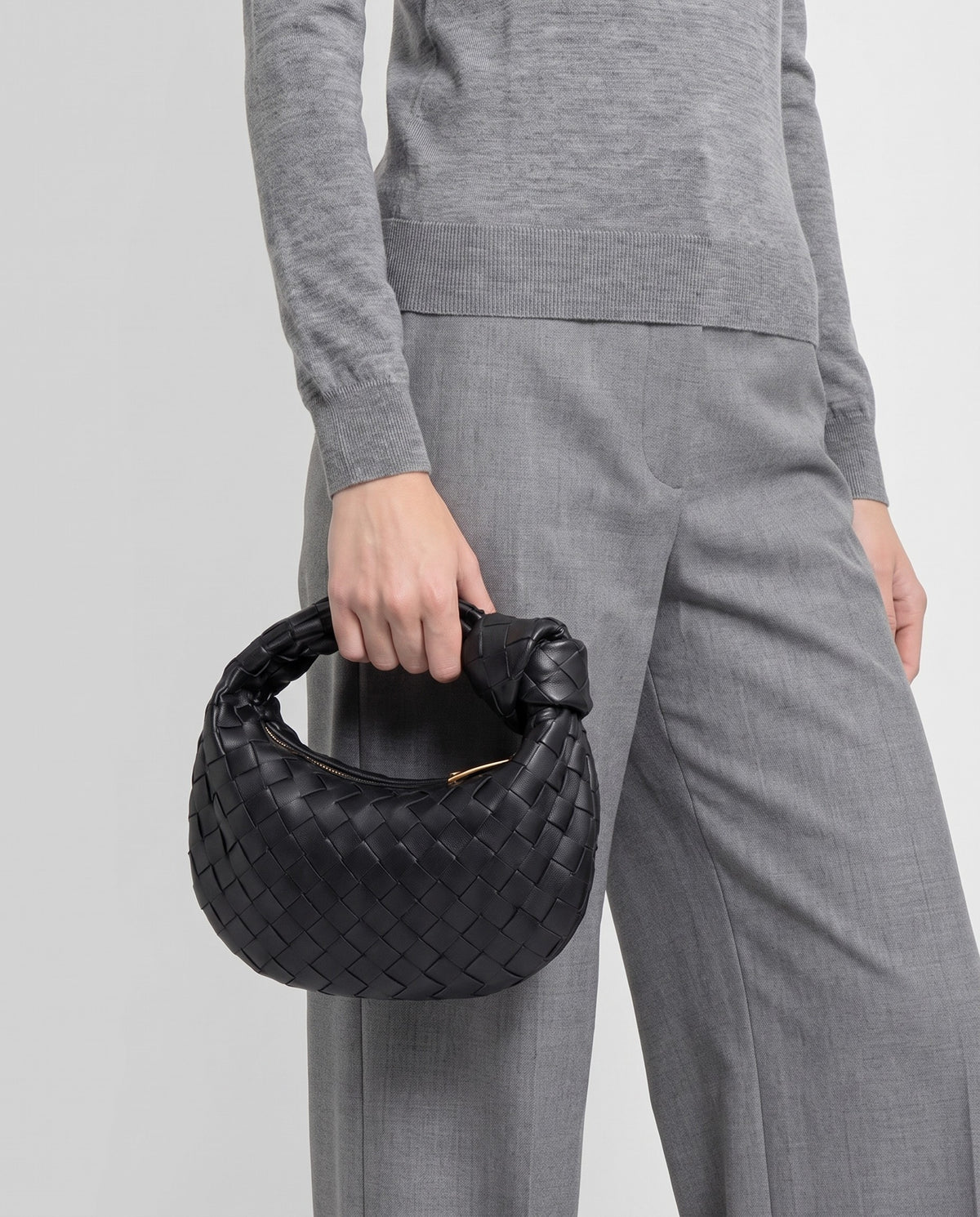 Knot Mini woven leather bag in Black – model carrying it