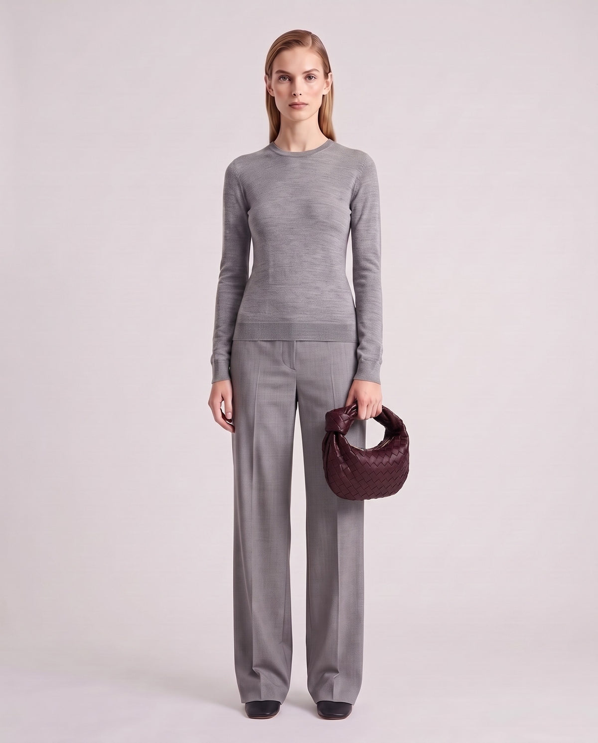 Knot Mini woven leather bag in Bordeaux – model holding it, full length