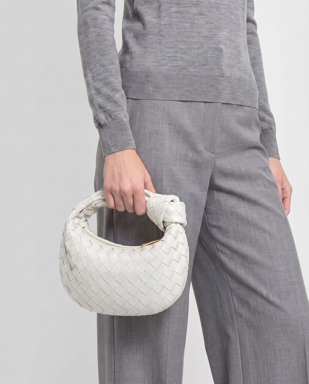 Knot Mini woven leather bag in Chalk – model carrying it